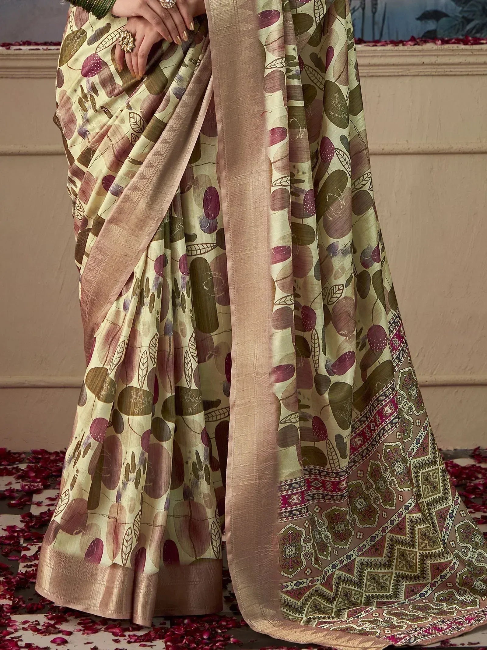 Elegant printed saree with leaf motifs and intricate border, perfect for ethnic occasions