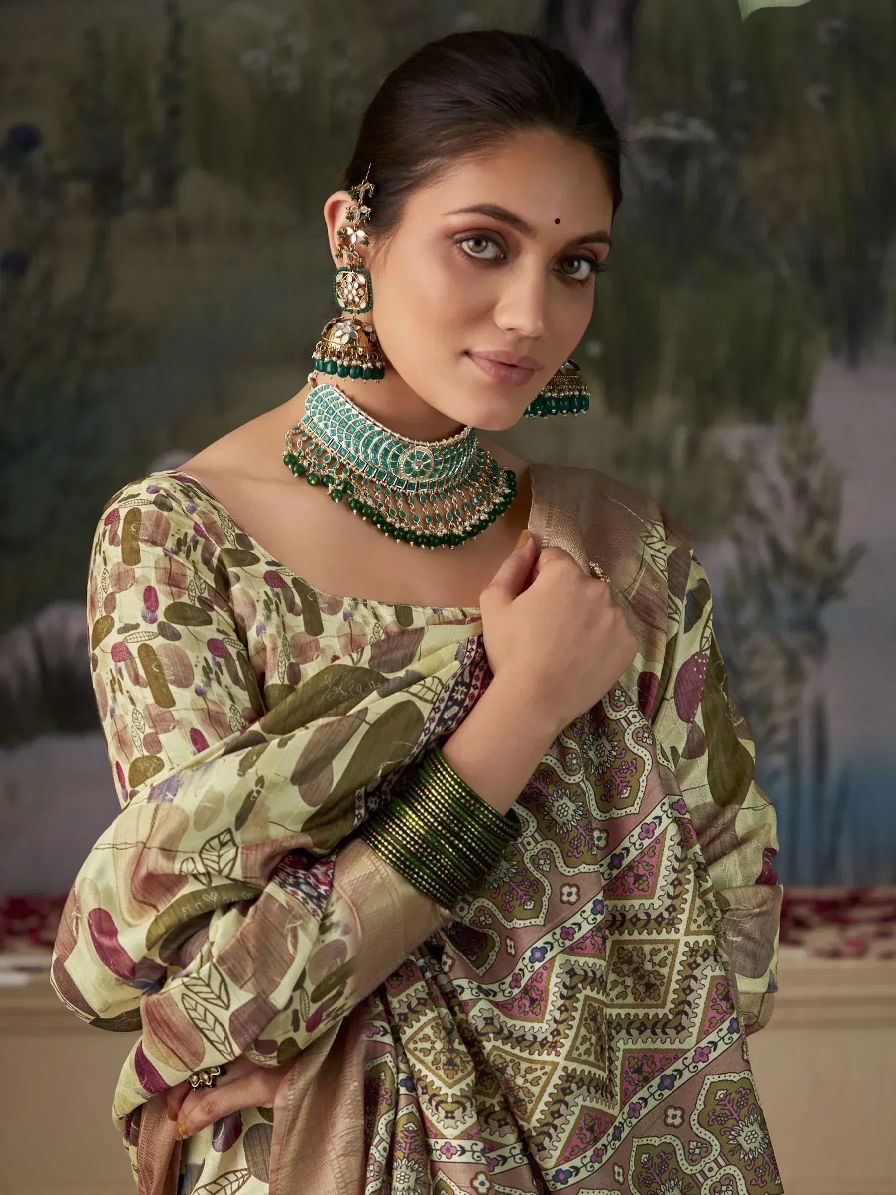 Woman in printed ethnic salwar kameez with green jewelry, perfect for Indian festive occasions