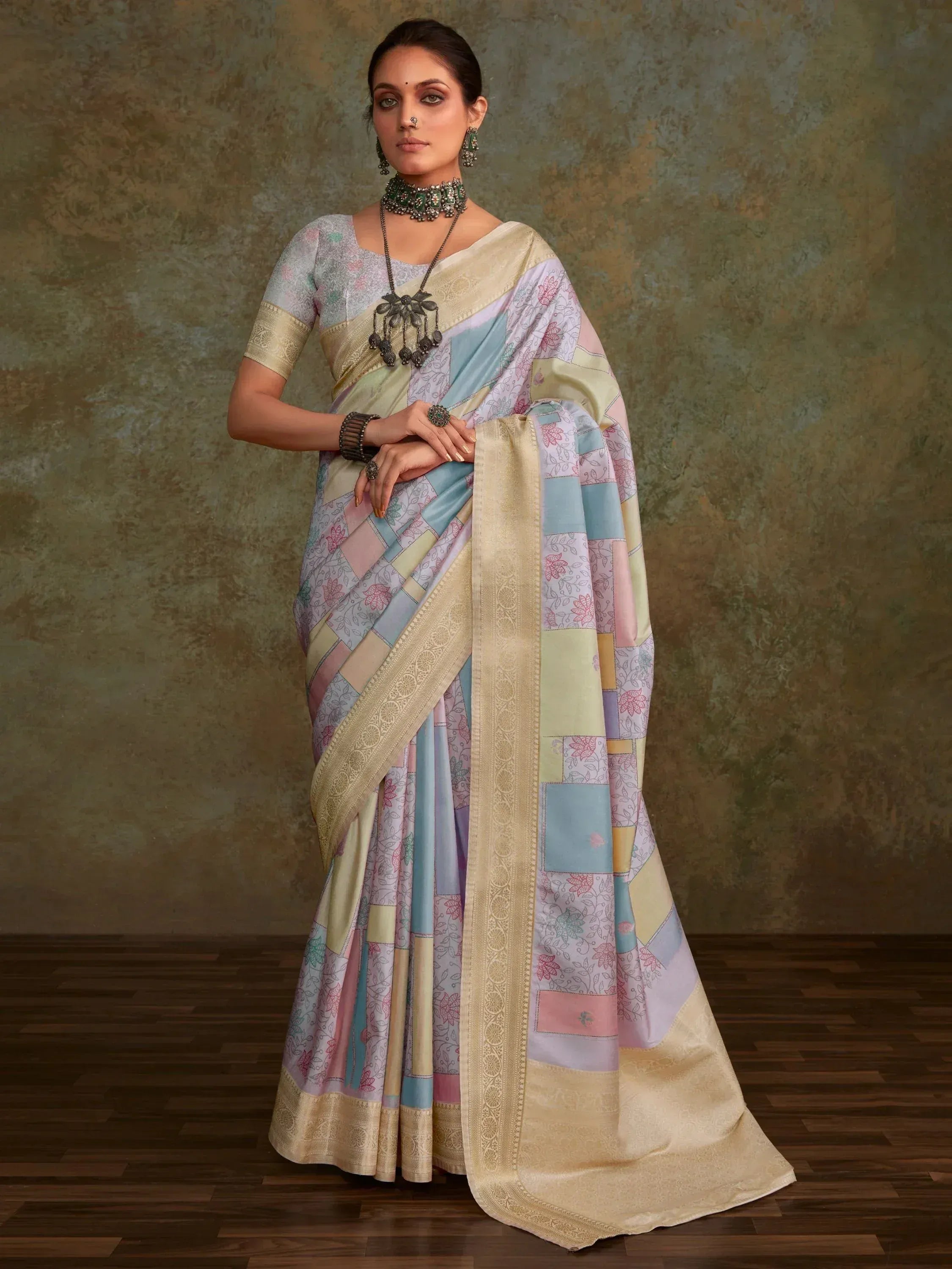 Pastel patchwork saree with floral print and gold border, styled with ethnic jewelry for Indian occasions