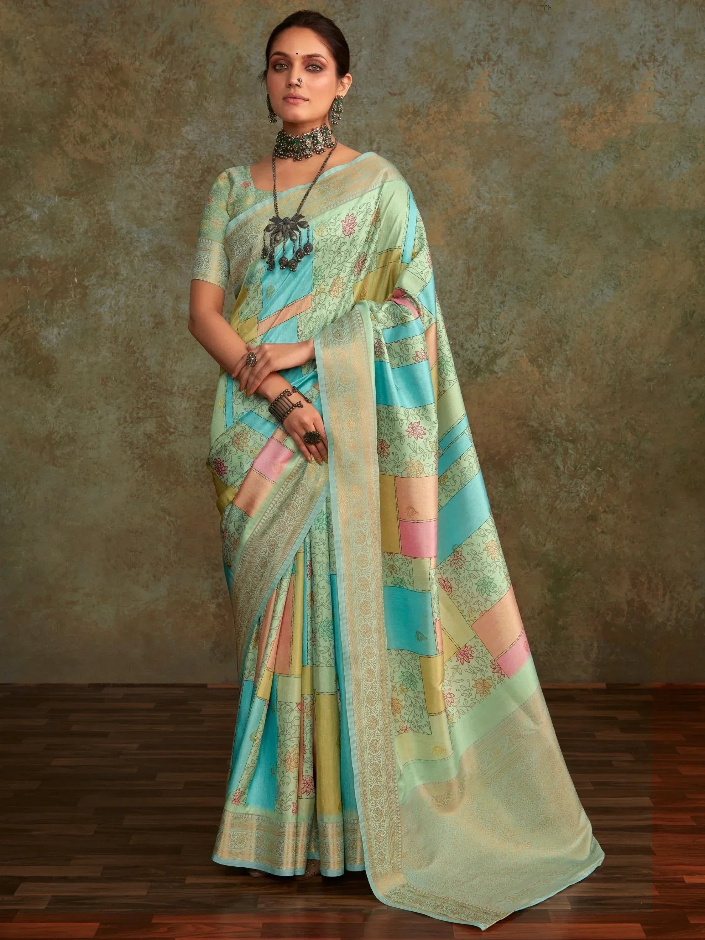 Woman in designer saree with floral patchwork, ethnic wear for festive occasions