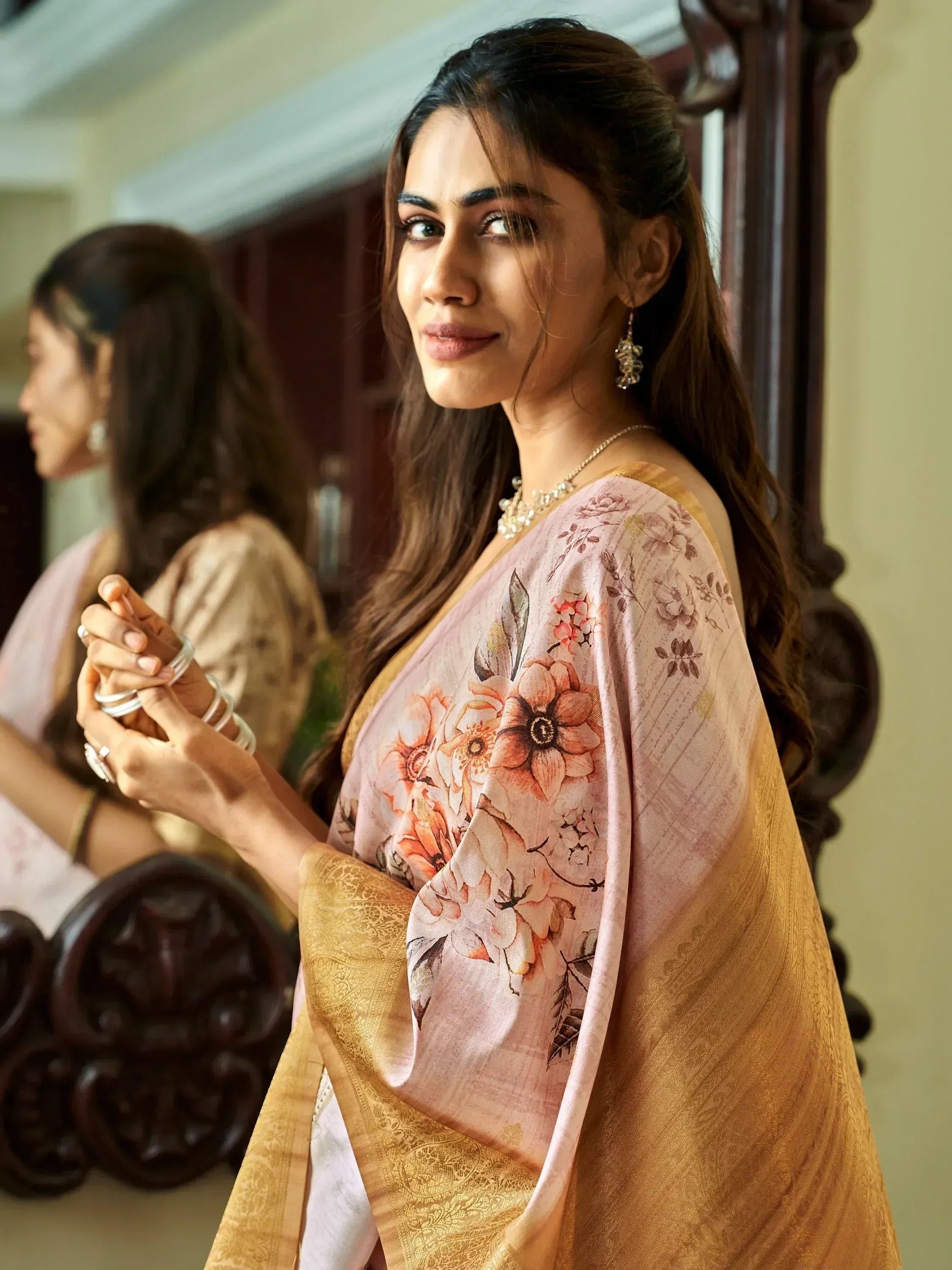 Elegant woman in floral print saree with golden border, traditional Indian ethnic wear