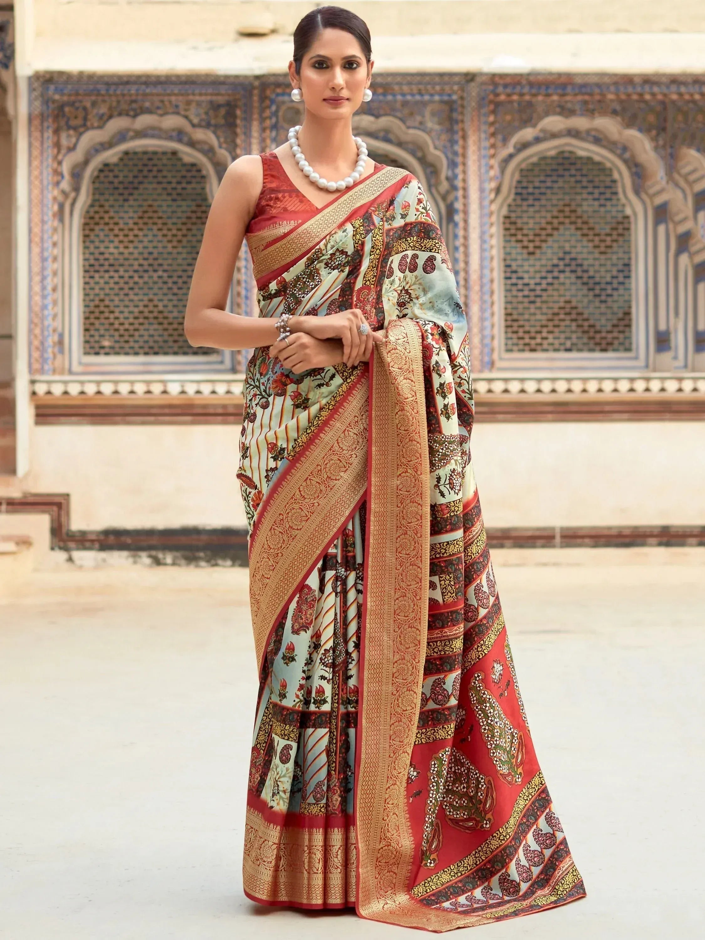 Woman in elegant floral print saree with golden border, styled for Indian ethnic wear occasions