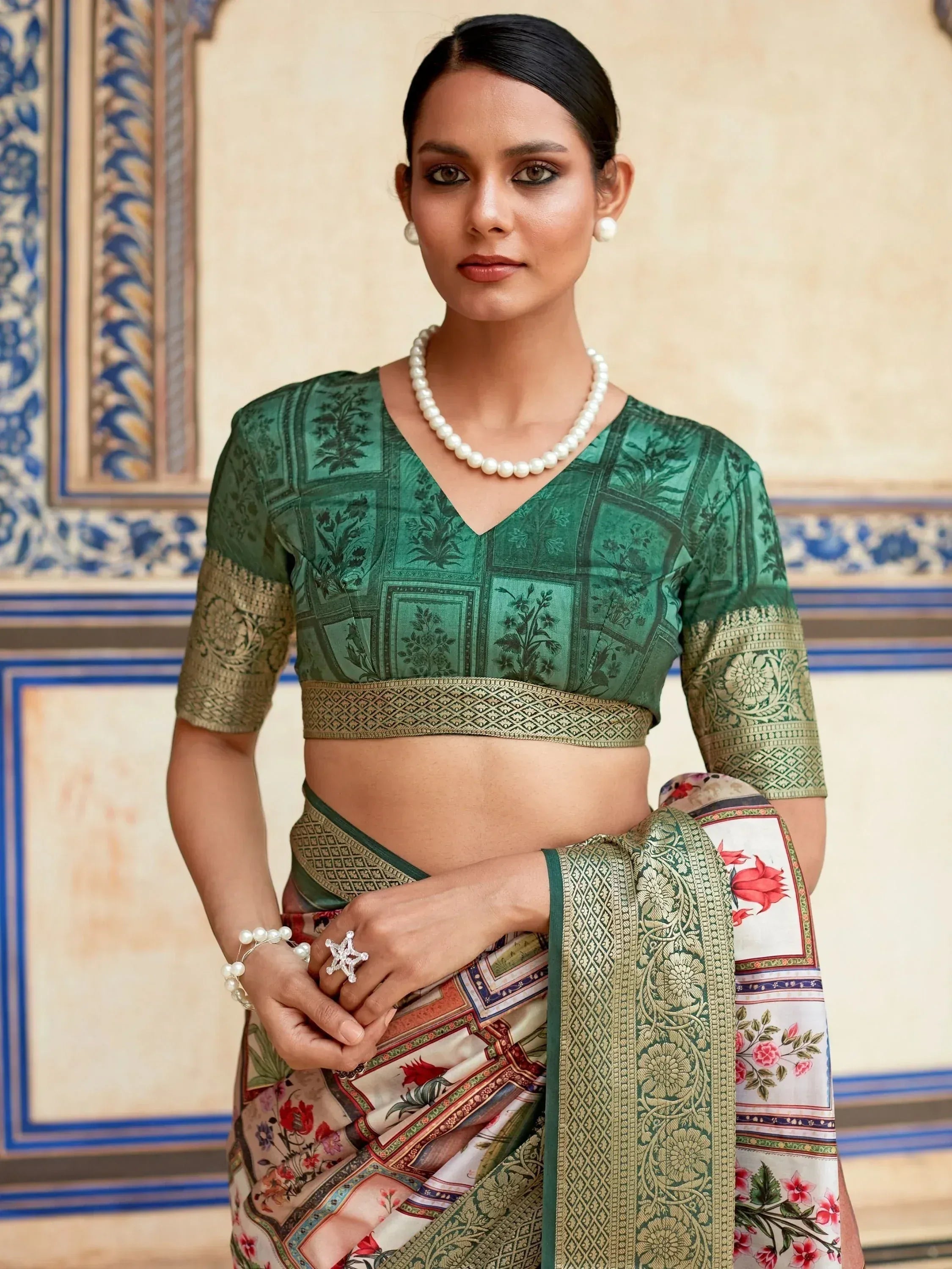 Woman in green printed saree with floral border and pearl jewelry, Indian ethnic wear