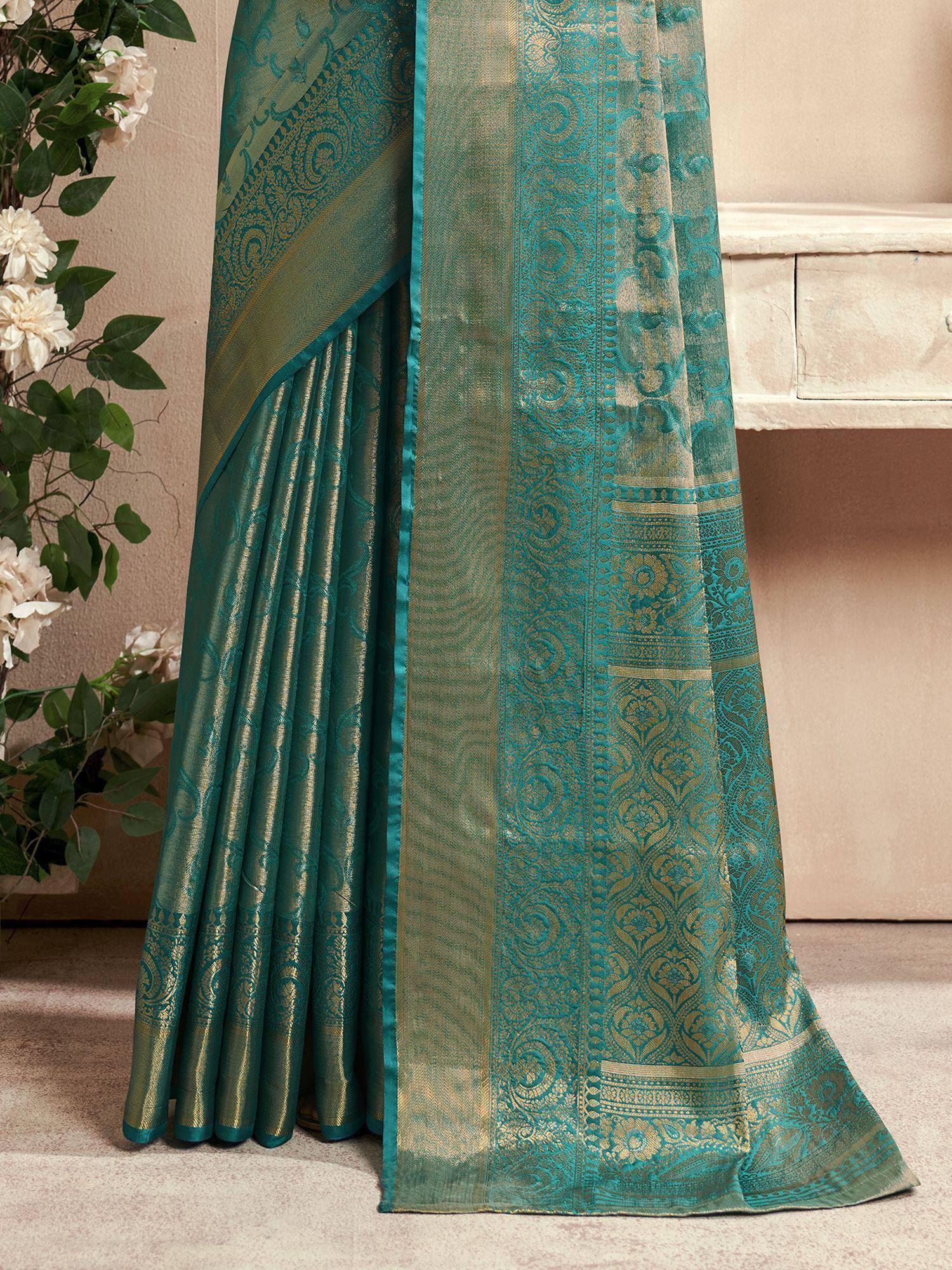 Teal and gold designer saree with intricate paisley and floral woven patterns, perfect for ethnic occasions.
