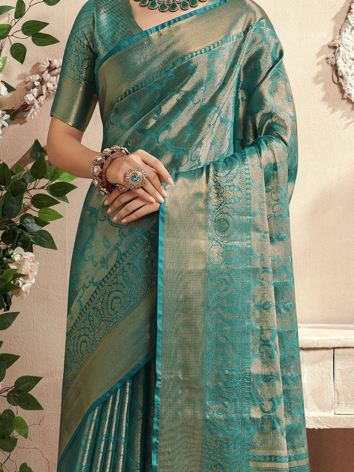 Teal and gold designer saree with intricate paisley patterns, perfect for Indian ethnic wear occasions.