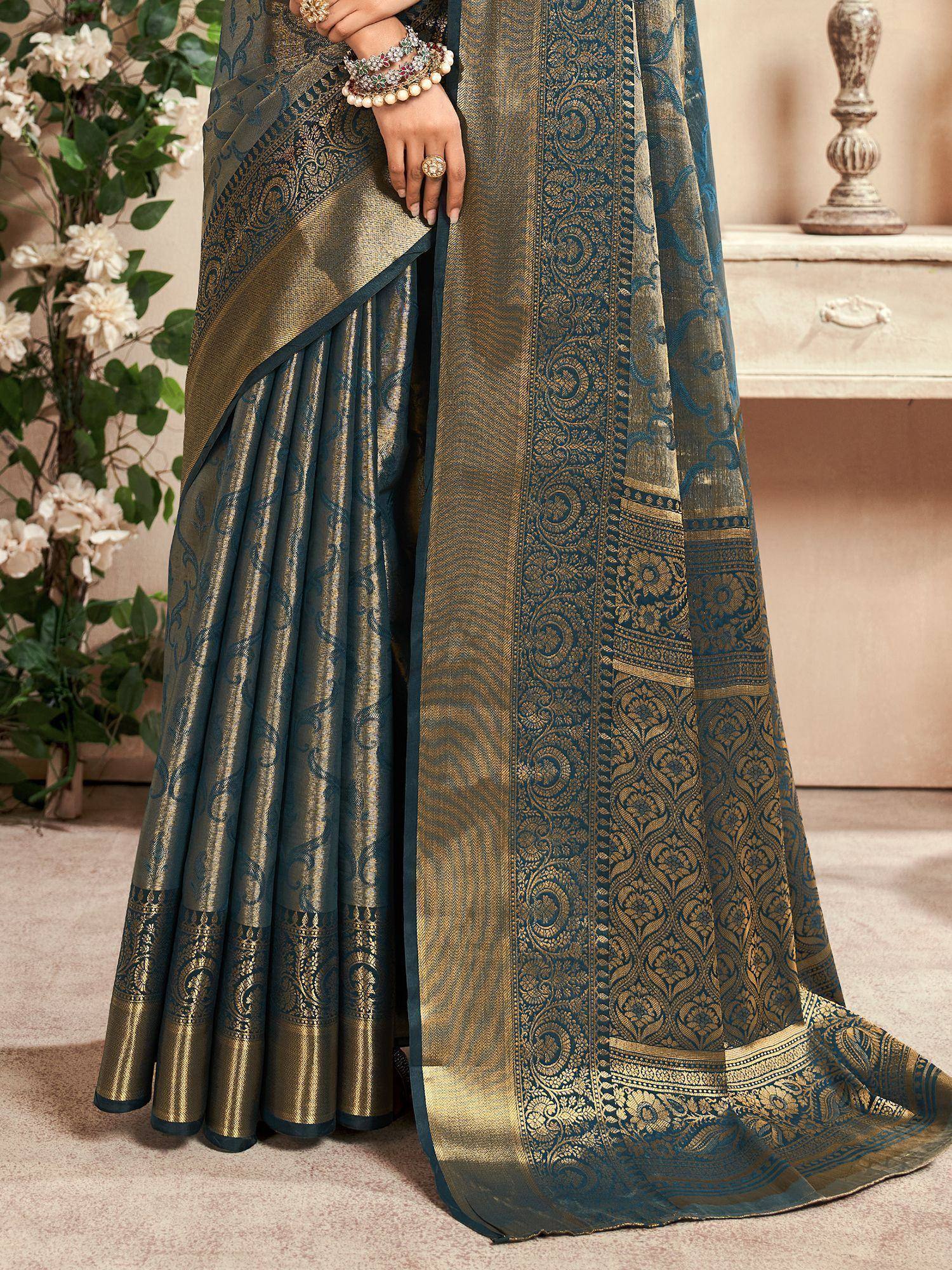 Teal and gold designer saree with intricate paisley border, perfect for ethnic occasions