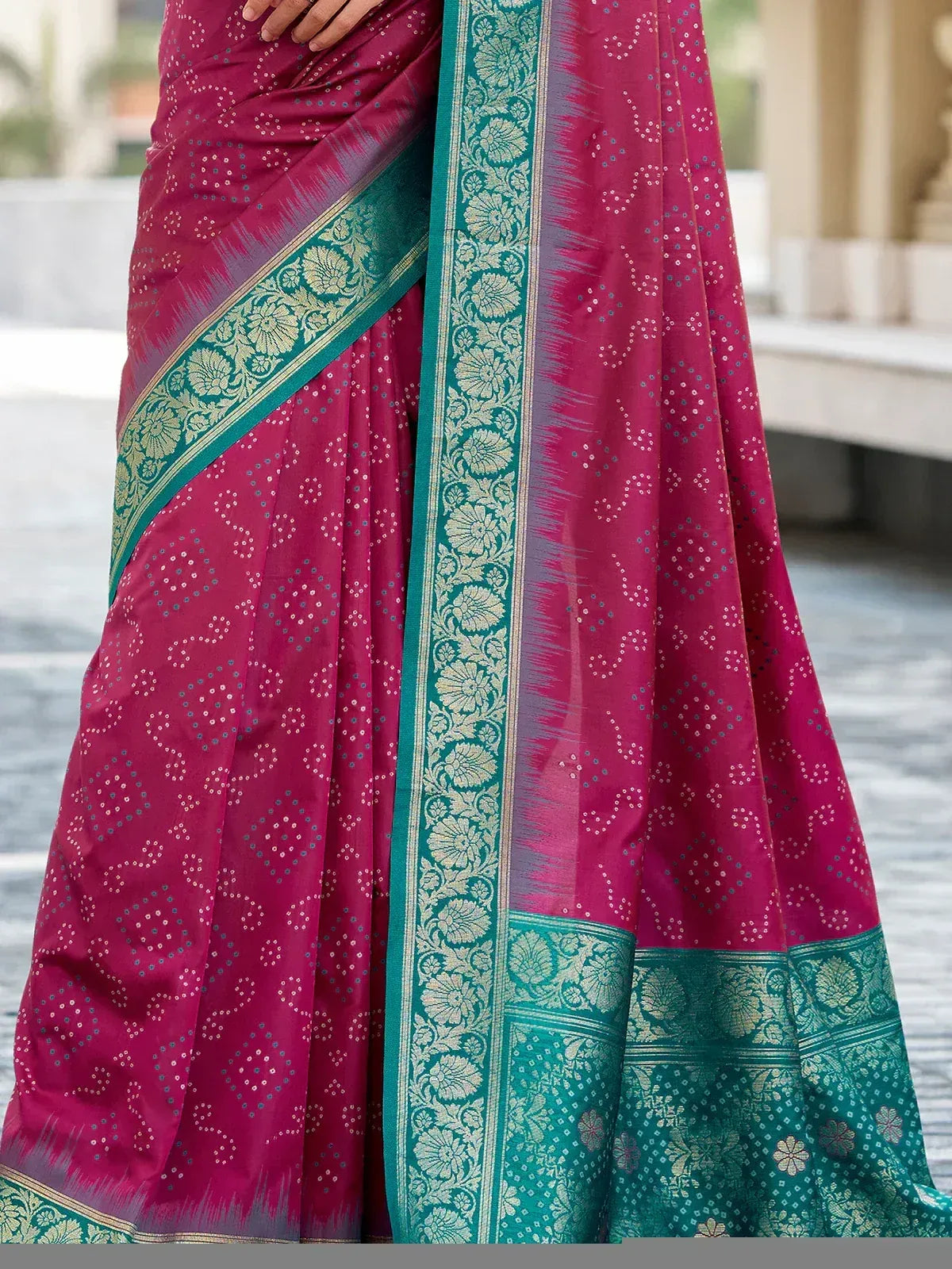 Pink and teal designer saree with floral border and woven motifs, ideal for ethnic occasions