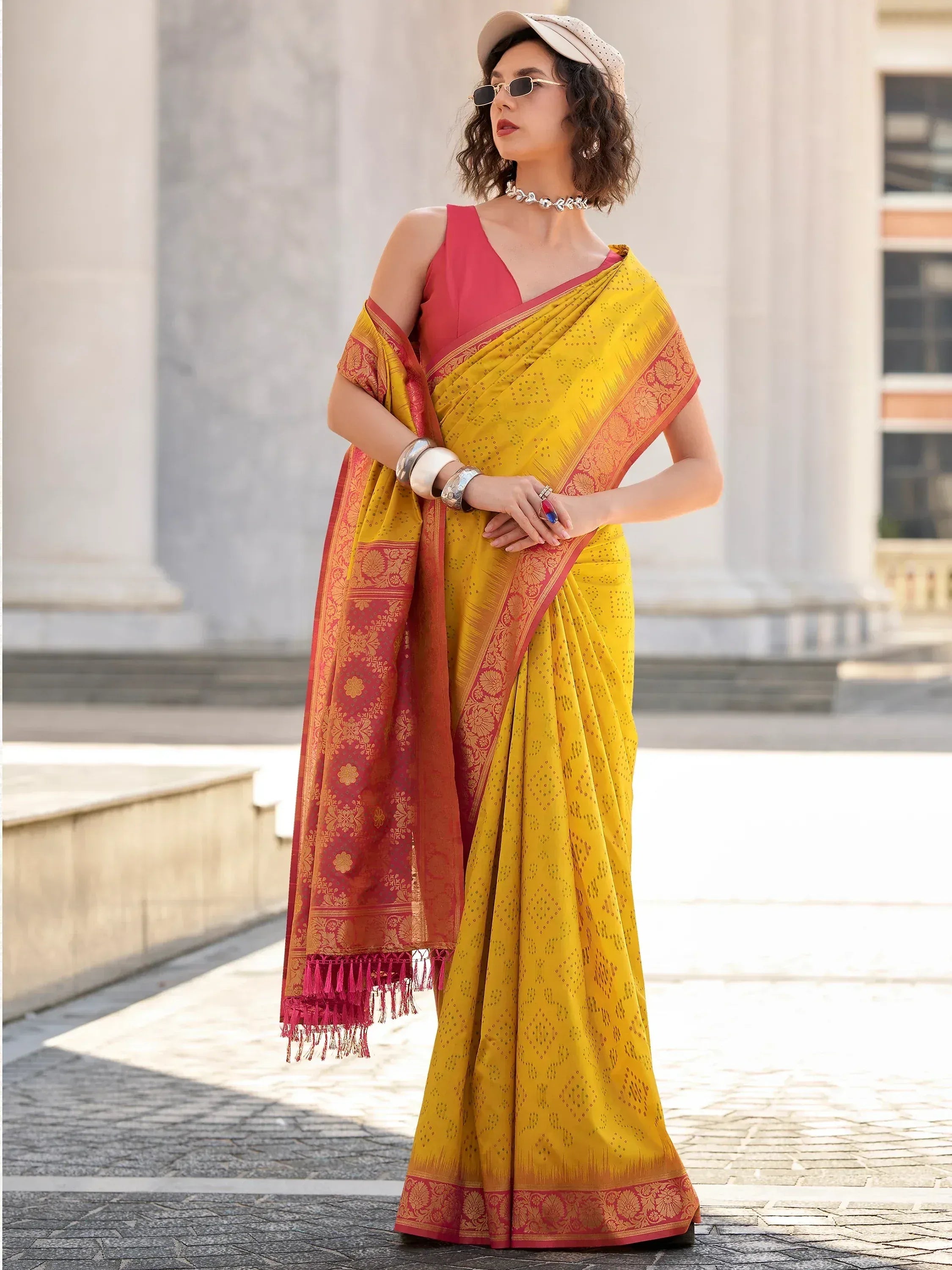 Yellow and red designer saree with gold motifs, paired with pink blouse, perfect for Indian ethnic wear