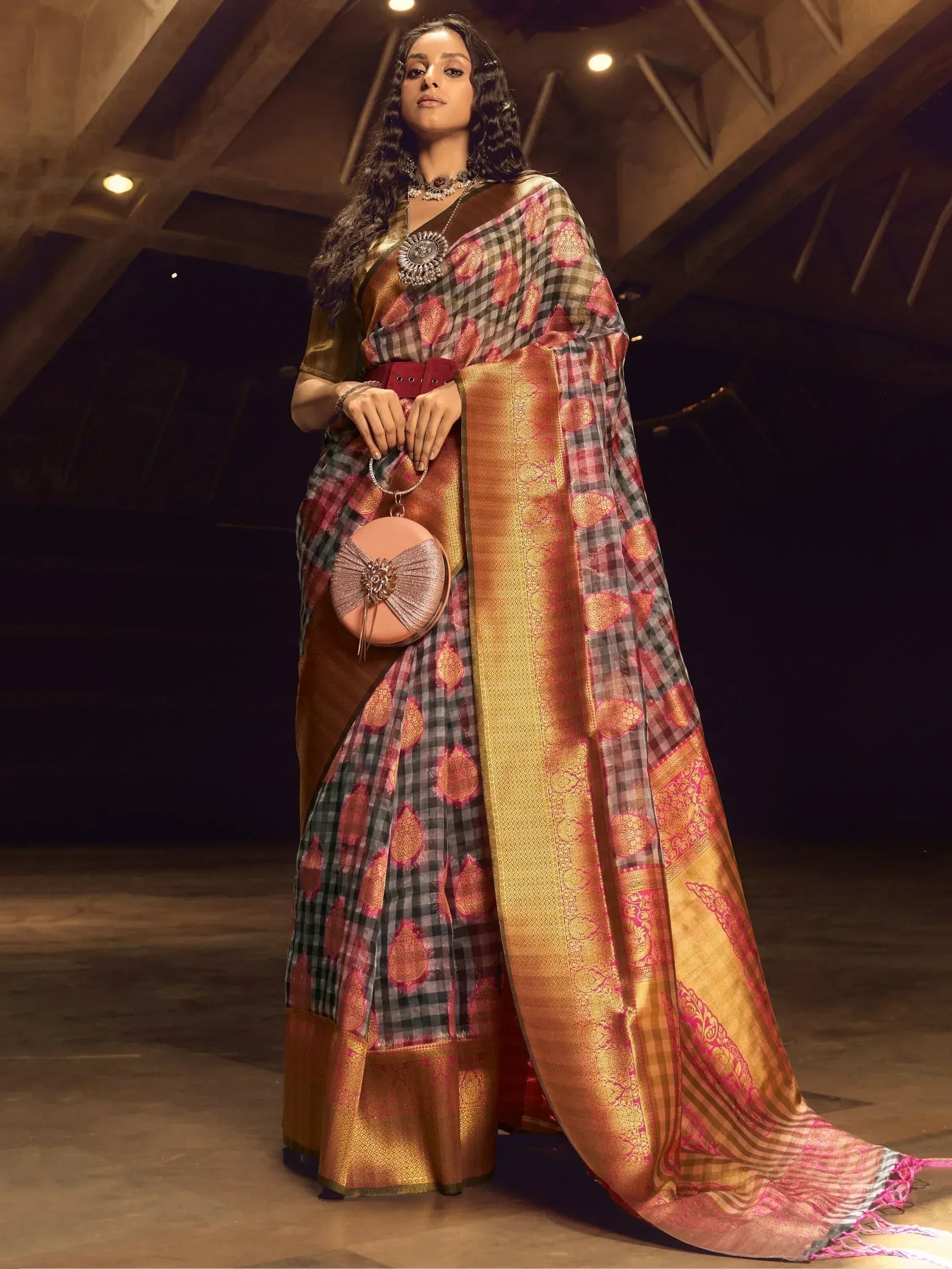 Woman in elegant checkered saree with gold border, ethnic wear for festive occasions