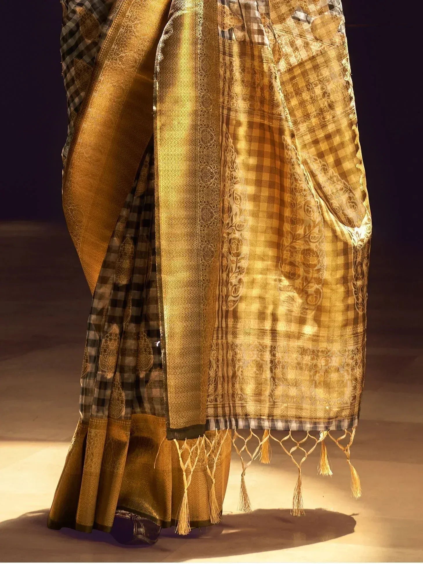 Golden checkered saree with intricate floral motifs and tassels, perfect for ethnic occasions