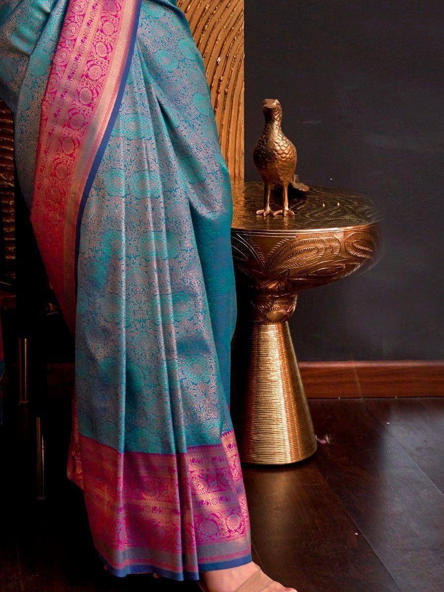 Teal and pink designer saree with intricate gold patterns, perfect for ethnic wear occasions