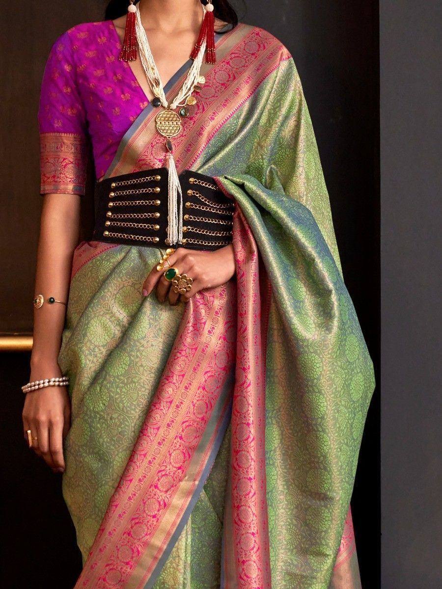 Green and pink designer saree with gold embroidery, paired with purple blouse and statement belt for ethnic wear