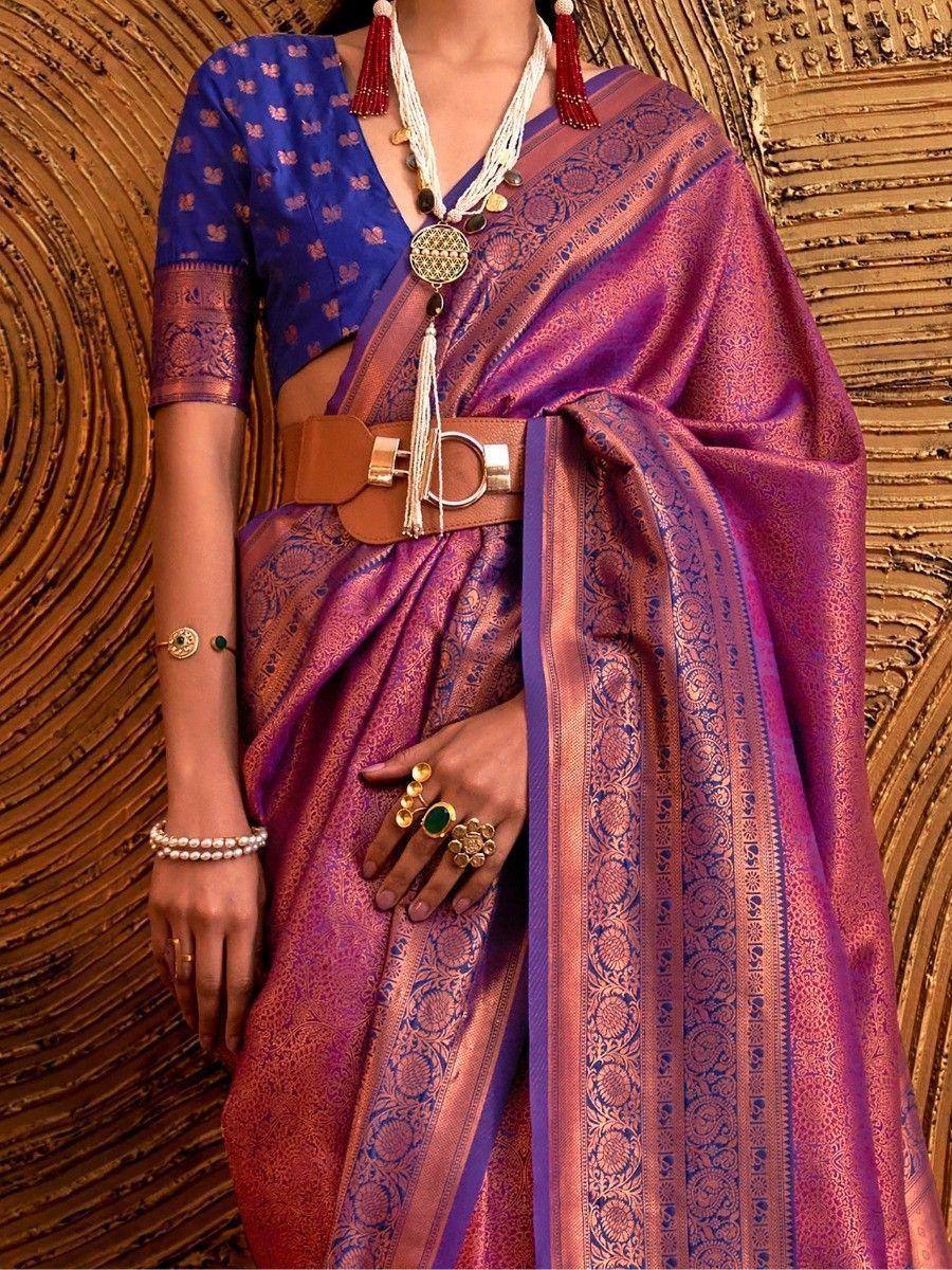 Purple and blue designer saree with gold embroidery, paired with a belt and ethnic jewelry for festive occasions