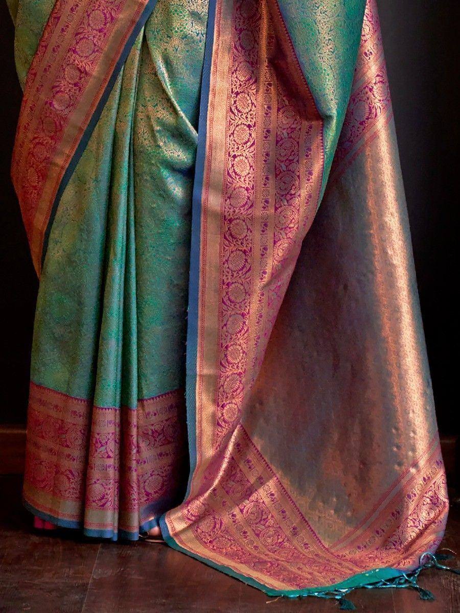 Teal and pink designer saree with intricate gold zari border, perfect for ethnic occasions