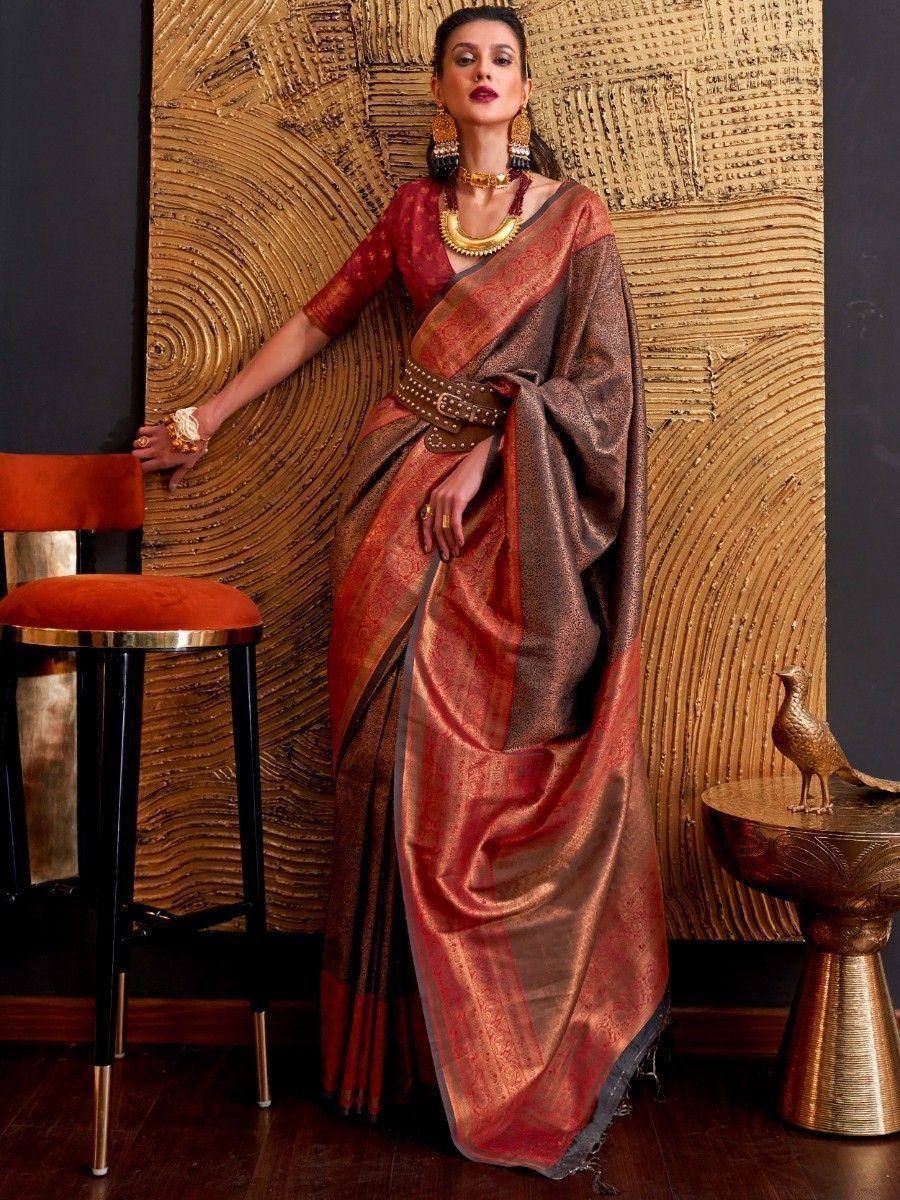 Elegant maroon and gold designer saree with traditional jewelry, perfect for Indian ethnic occasions.