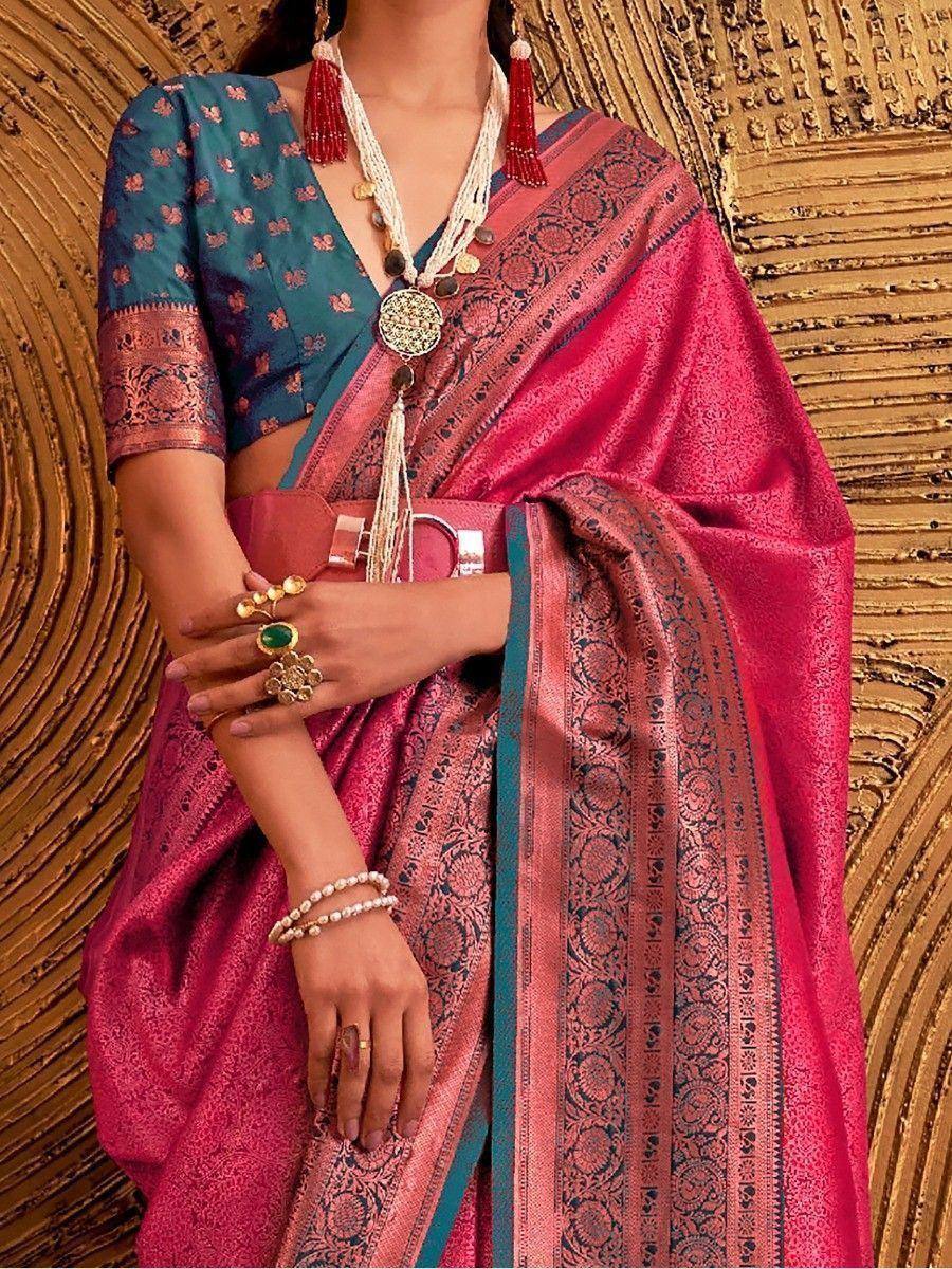 Pink and teal designer saree with intricate embroidery, paired with statement jewelry for ethnic wear