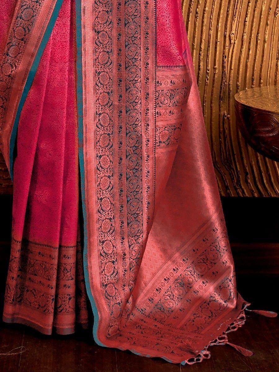 Pink and teal designer saree with intricate woven border and tassels, ideal for ethnic occasions