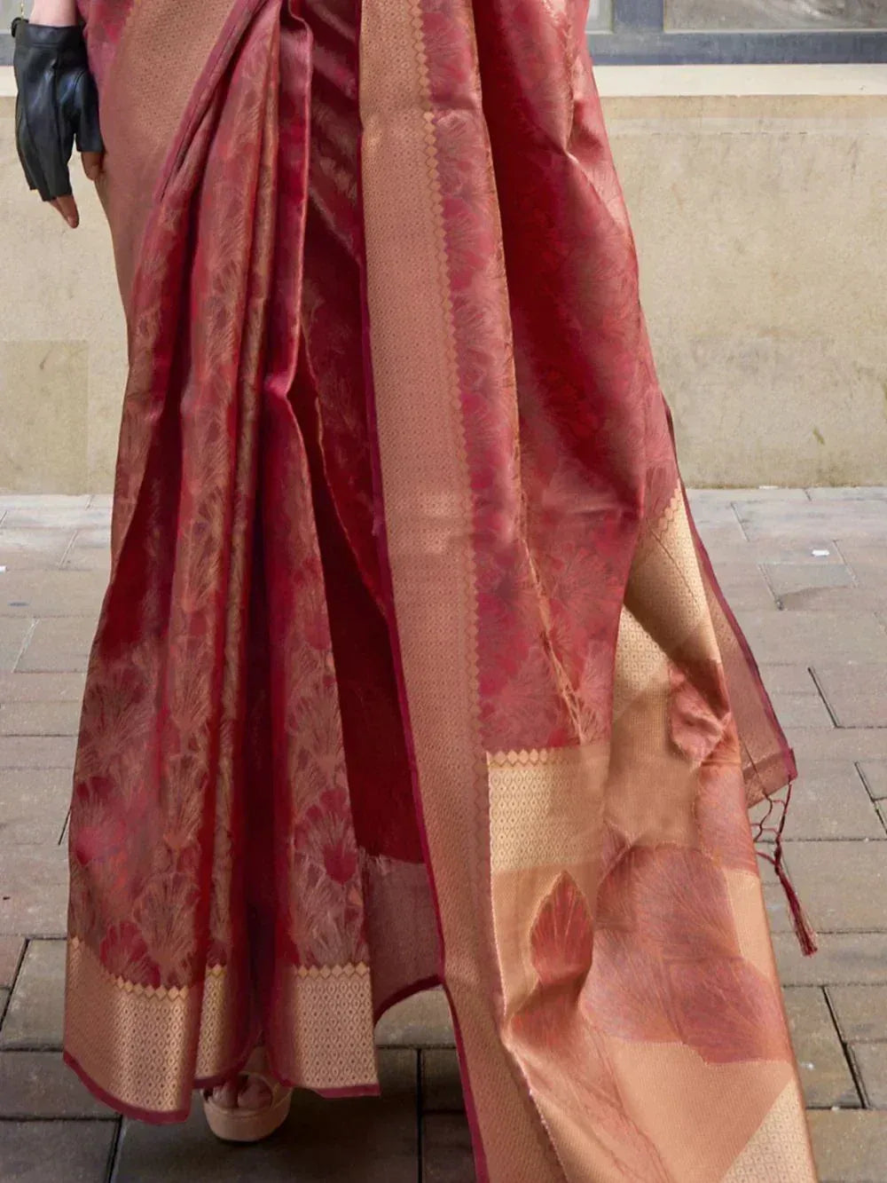 Rich red and gold designer saree with floral motifs and woven border, perfect for ethnic occasions
