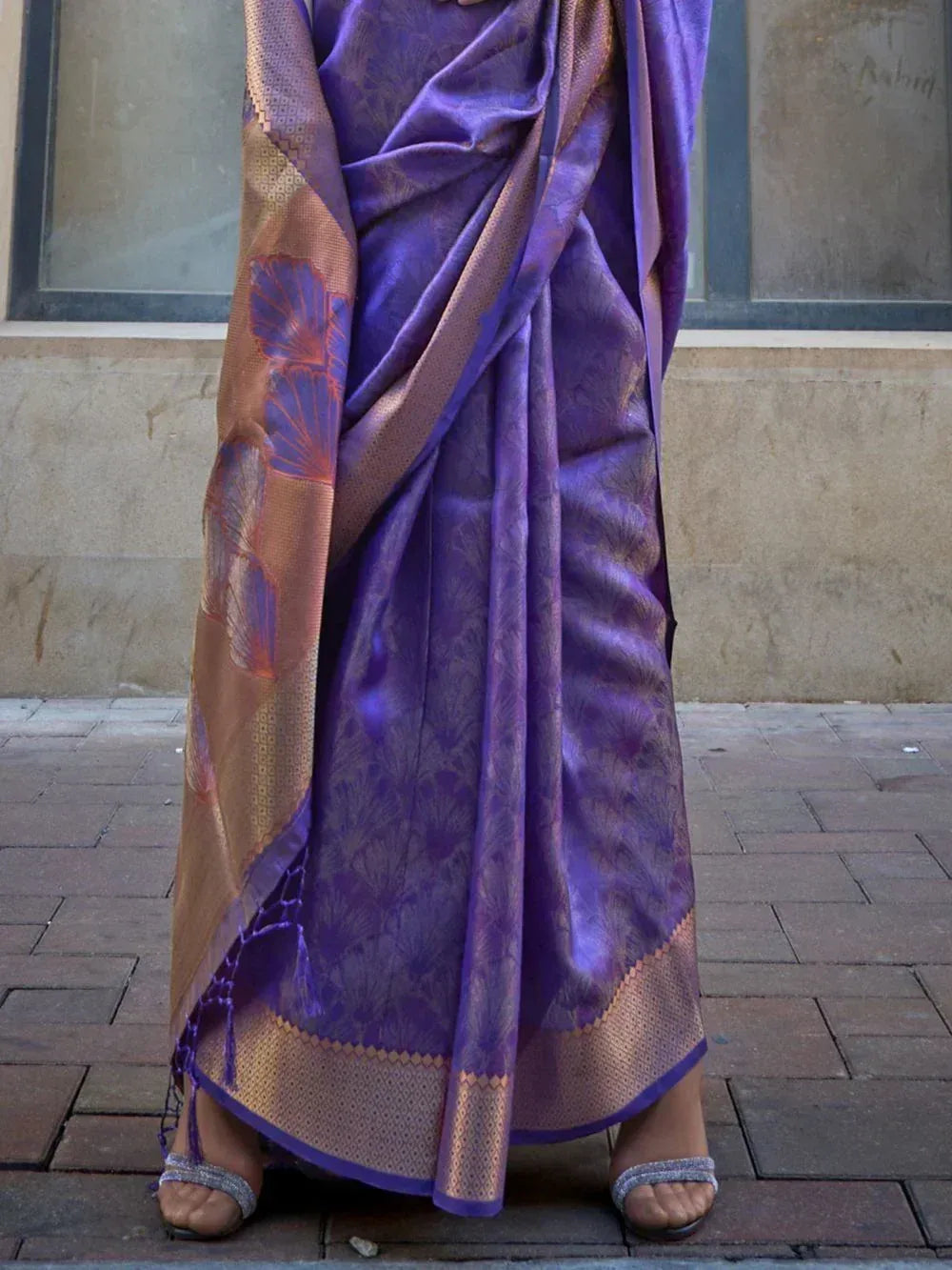 Purple designer saree with gold border and floral motifs, perfect for ethnic occasions