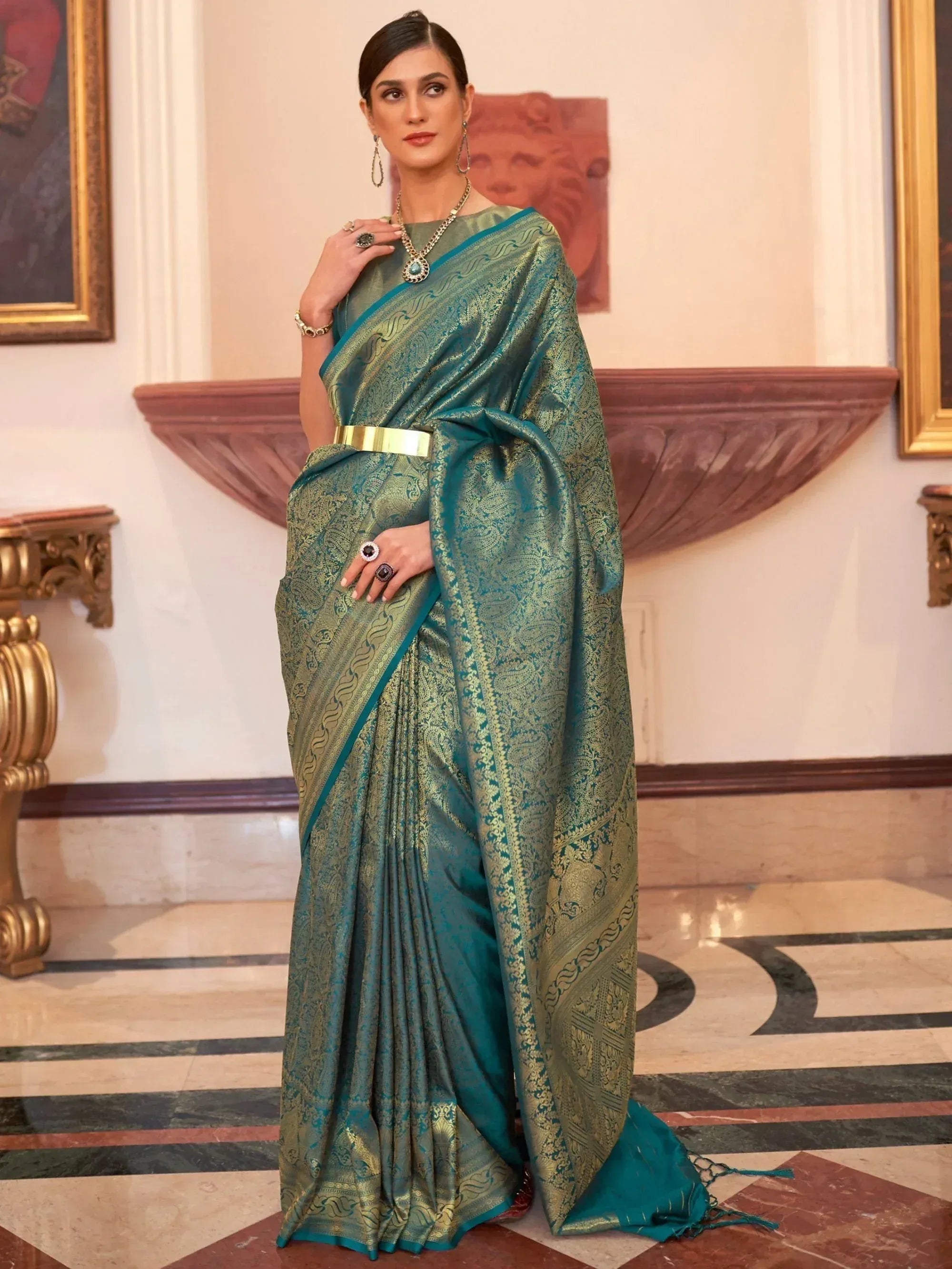 Elegant teal and gold designer saree with intricate paisley weave, perfect for Indian ethnic occasions.
