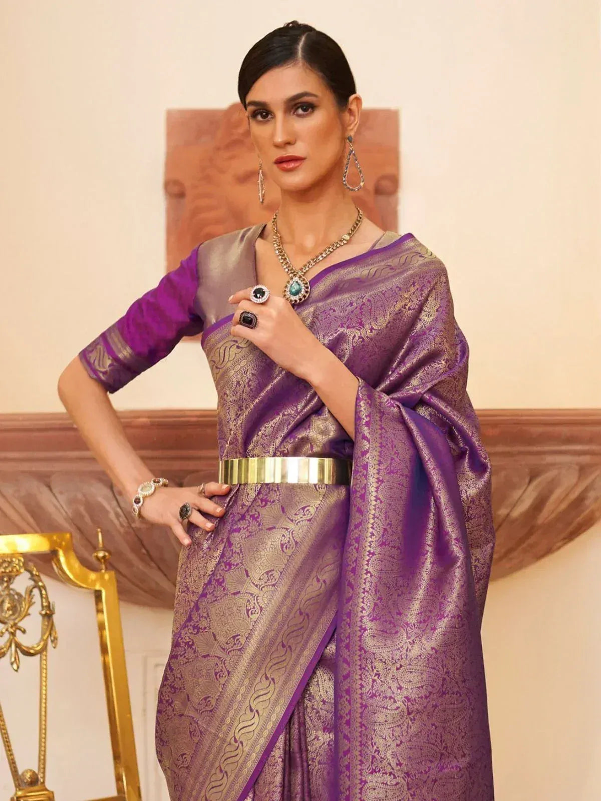 Purple and gold designer saree with intricate paisley weave, paired with statement jewelry for ethnic occasions