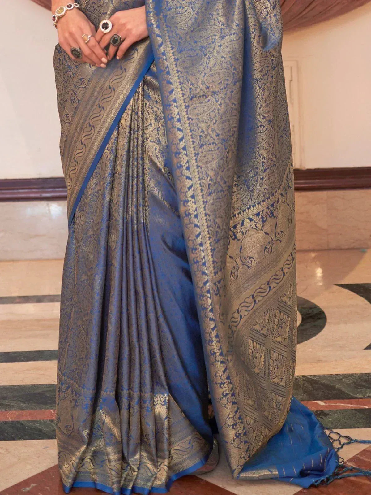 Blue and gold designer saree with intricate paisley and elephant motifs, perfect for ethnic occasions.