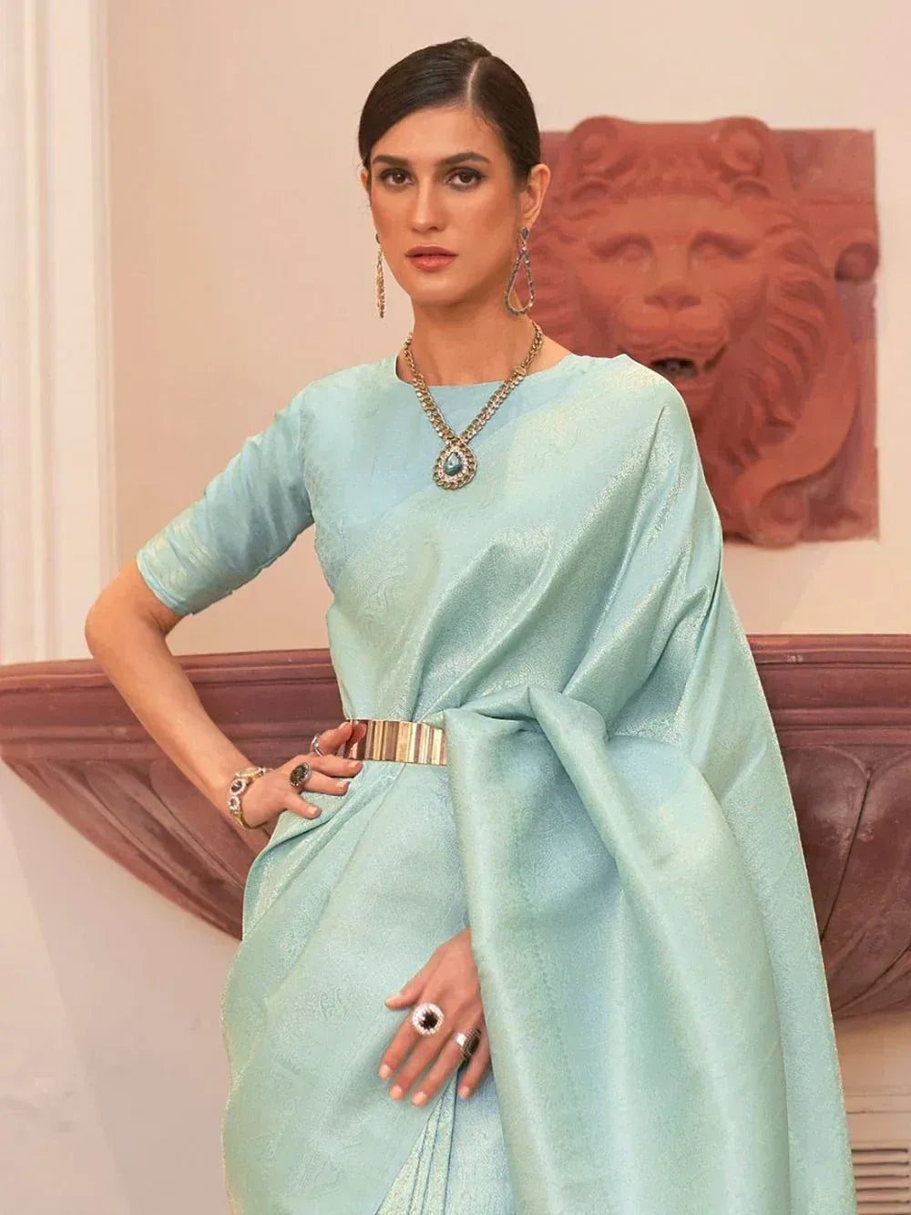 Mint green designer saree with gold belt, perfect for ethnic occasions and festive wear