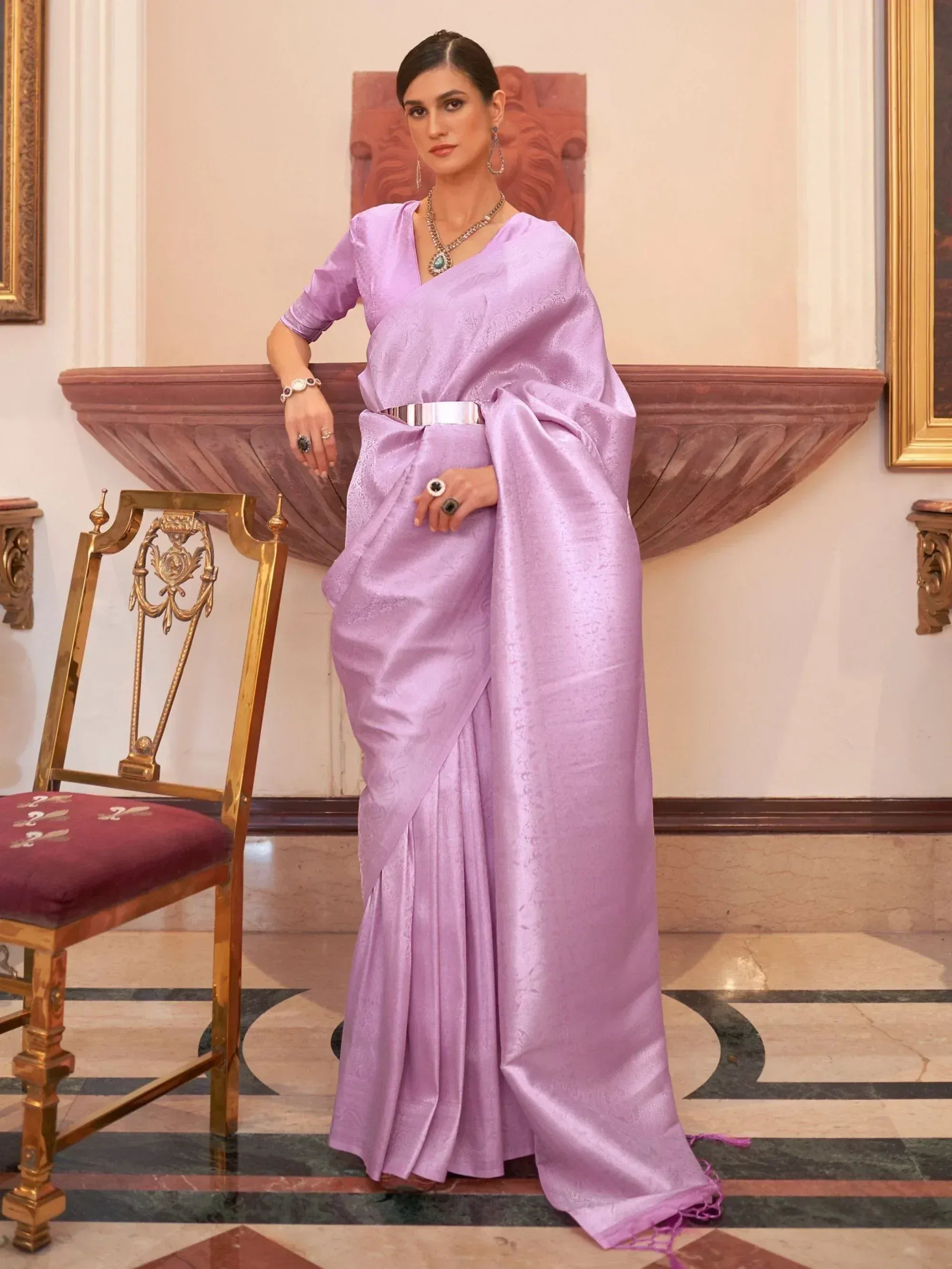 Lavender silk saree with V-neck blouse, silver belt, and statement jewelry for Indian ethnic wear
