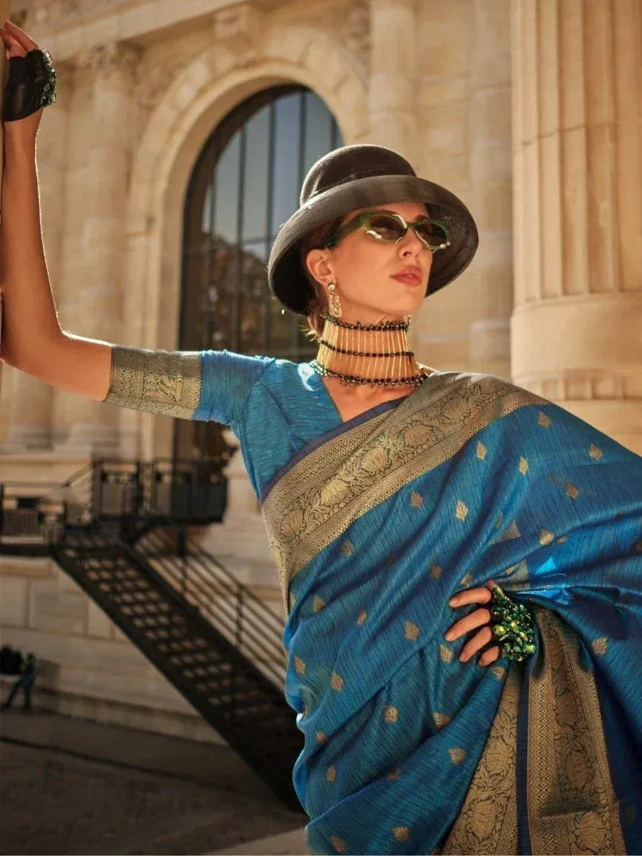 Blue designer saree with gold embroidery, styled with hat and sunglasses for ethnic fashion