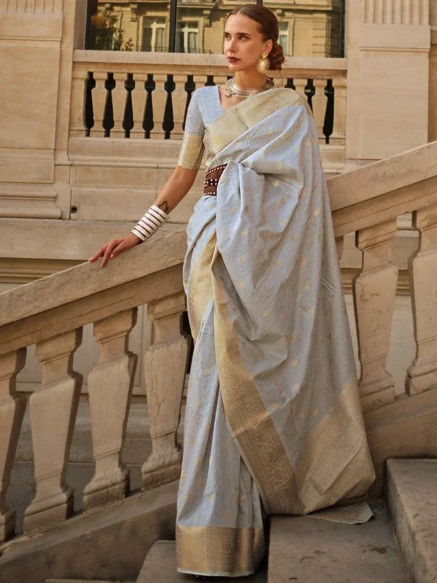 Light blue designer saree with gold border and blouse, styled for ethnic occasions