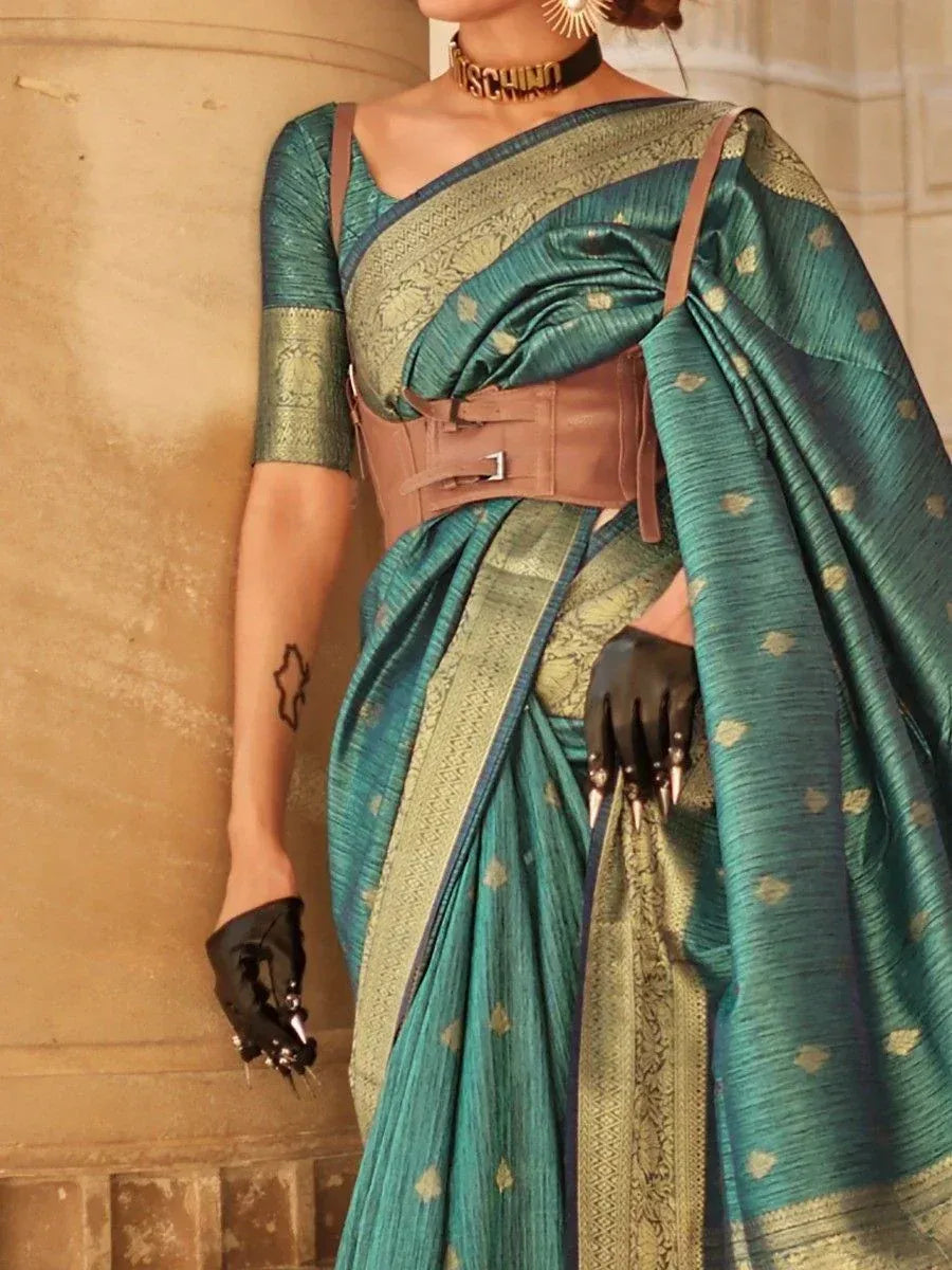 Teal designer saree with gold motifs, corset belt, and black gloves for ethnic wear