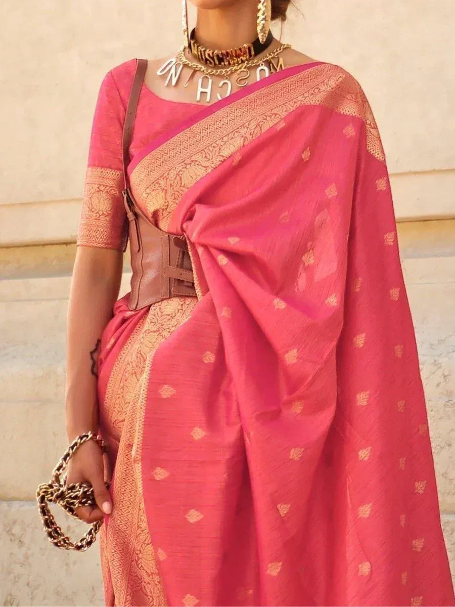 Pink ethnic saree with gold motifs, paired with designer blouse and statement jewelry for festive occasions