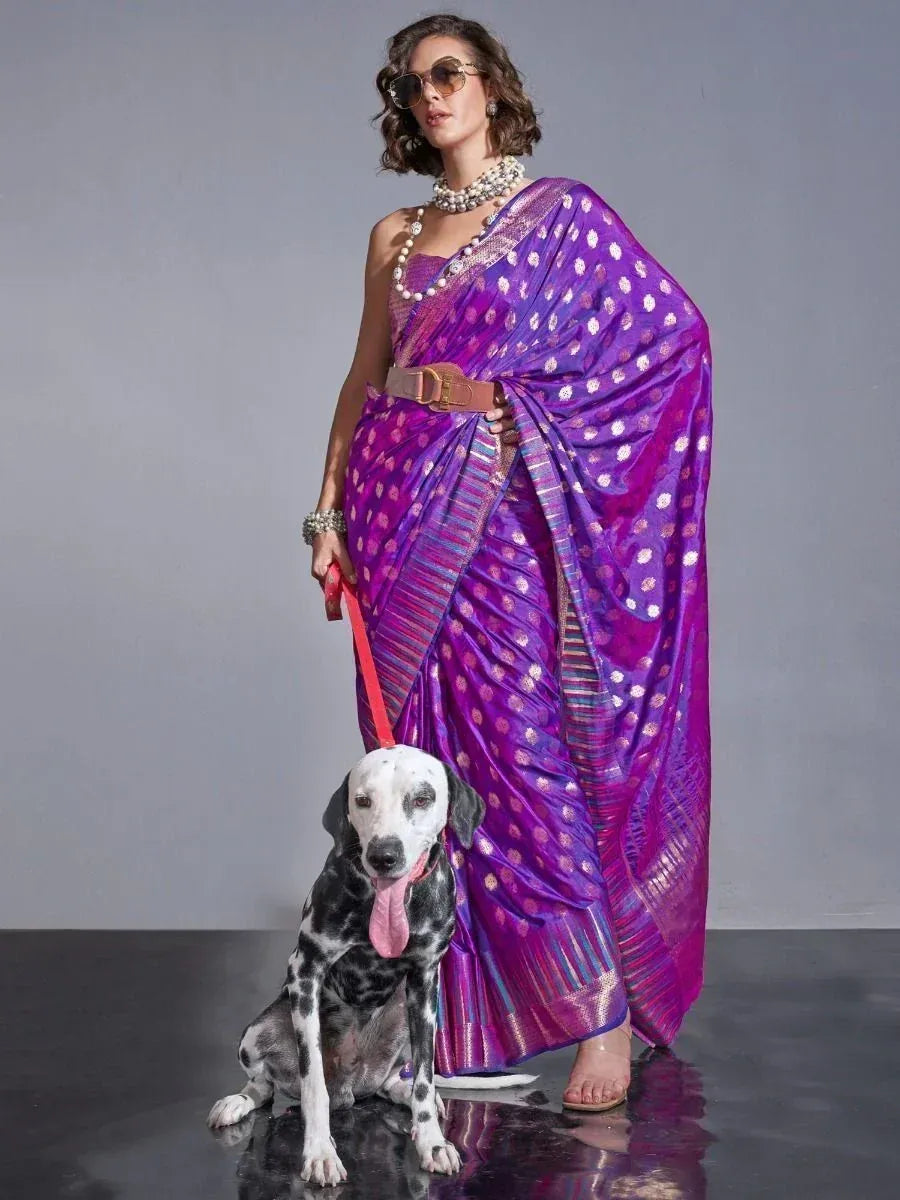 Woman in purple designer saree with gold dots, styled with belt and pearls, posing with Dalmatian dog