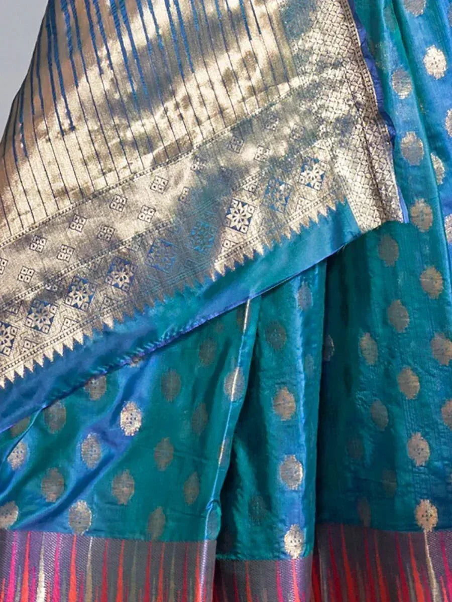 Teal blue silk saree with gold zari buta motifs and intricate temple border, perfect for Indian ethnic wear.