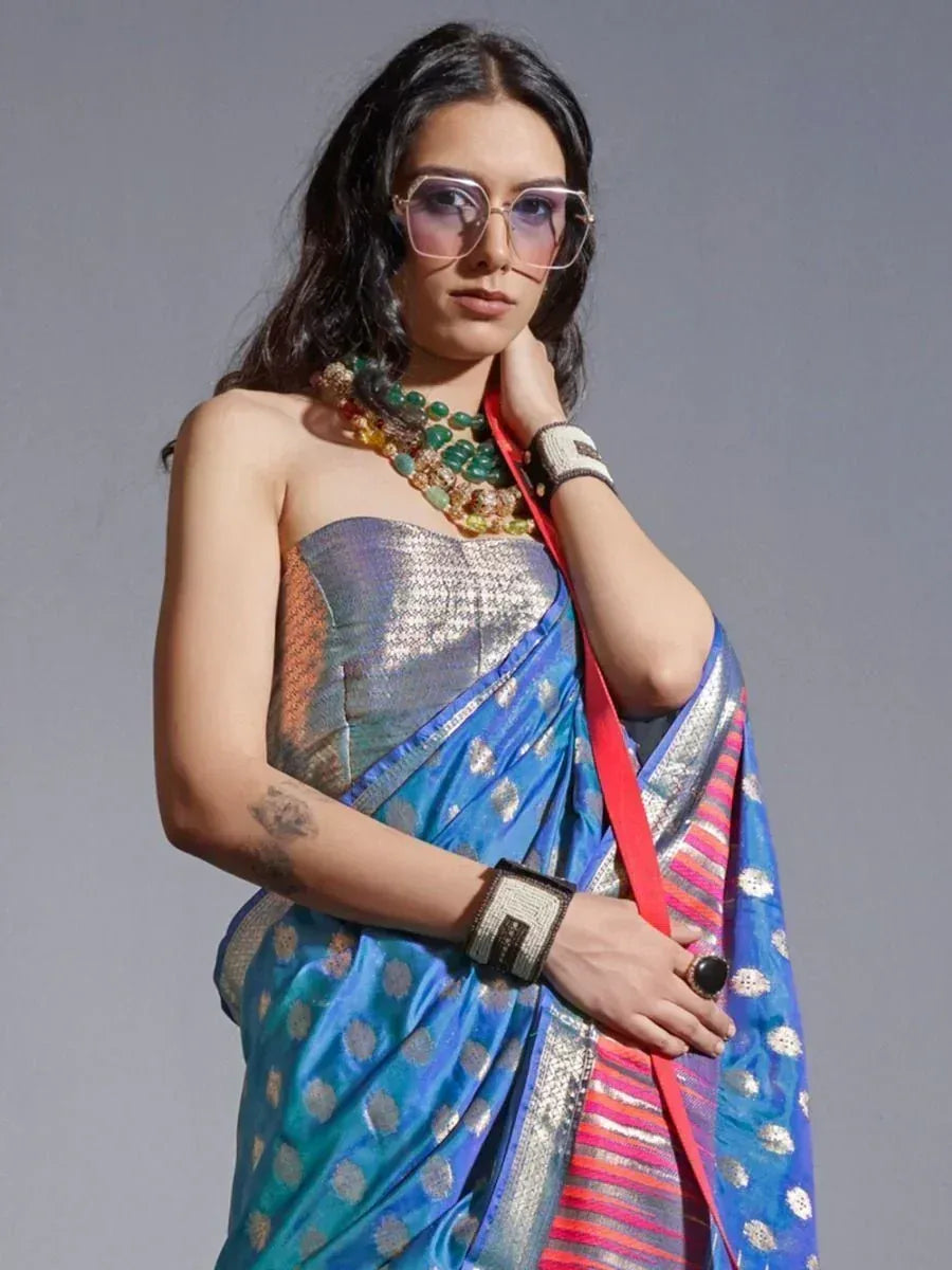 Blue printed saree with silver motifs, paired with statement jewelry and modern sunglasses for ethnic fashion