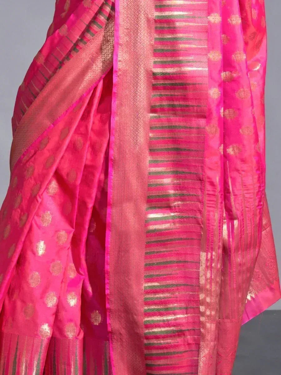 Vibrant pink ethnic saree with gold motifs and striped border, perfect for festive occasions
