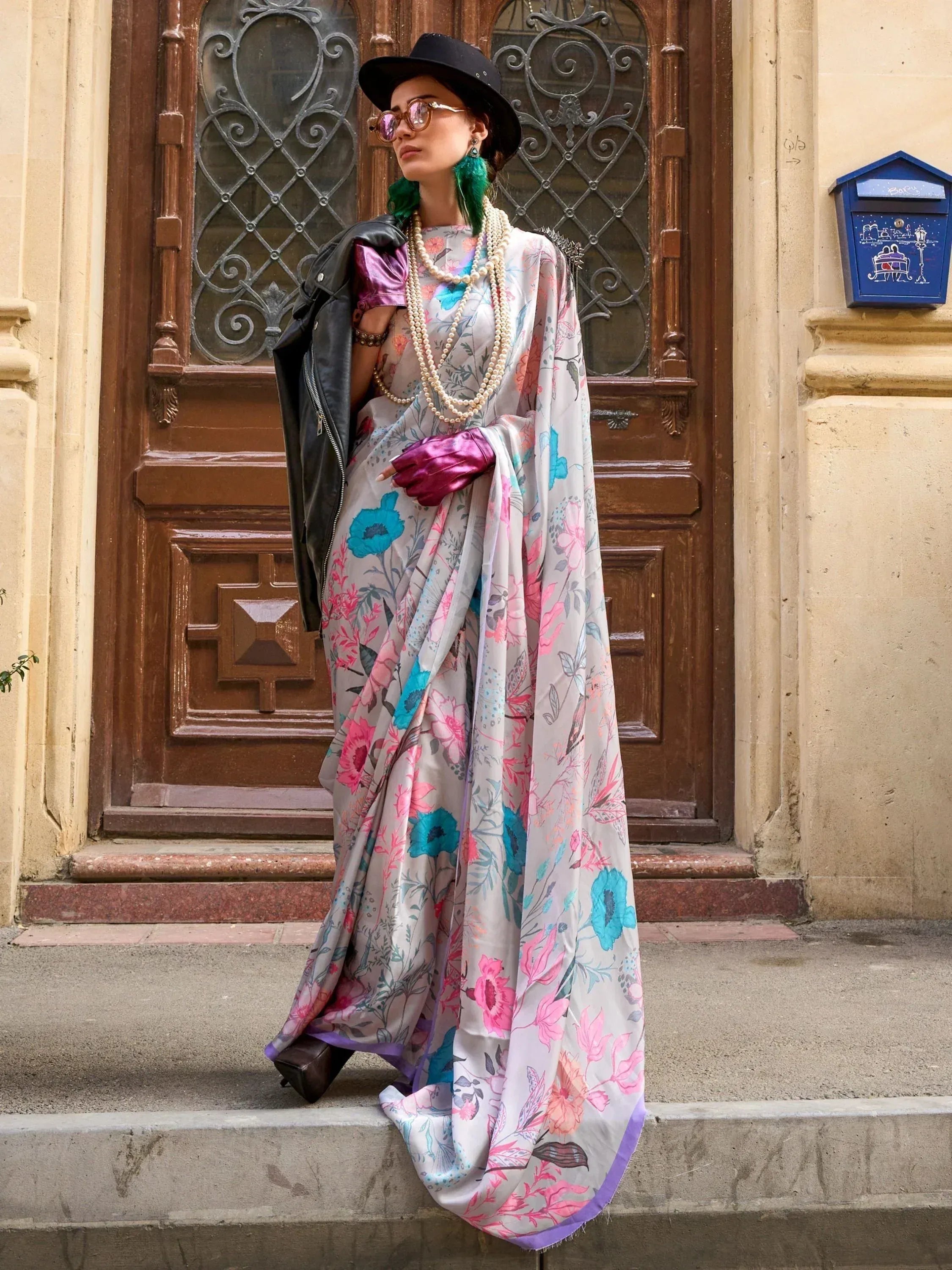 Floral print saree with purple blouse, black hat, and leather jacket for ethnic fashion