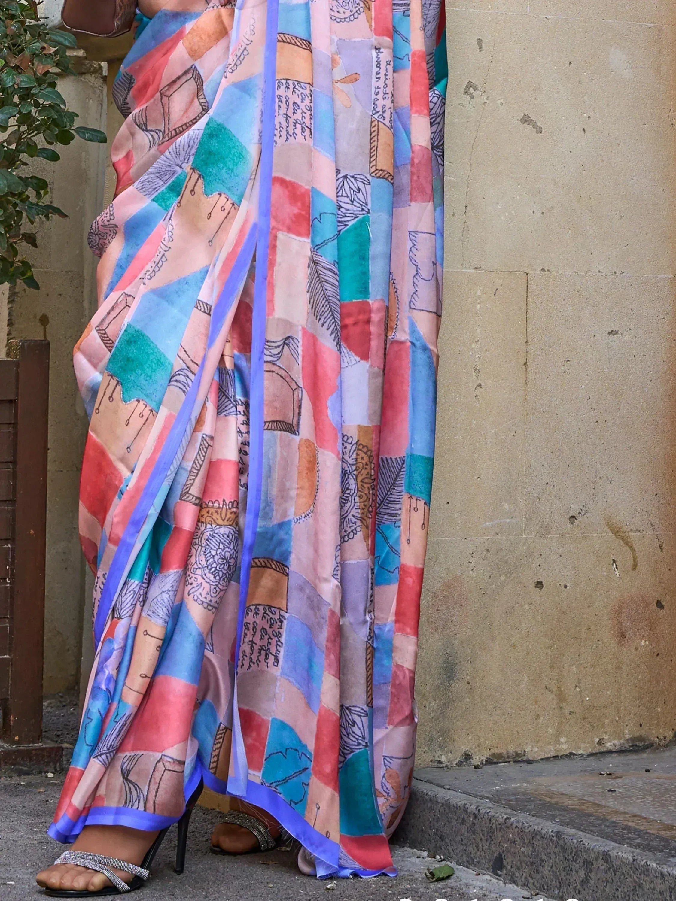 Colorful printed saree with abstract patchwork design, perfect for ethnic wear occasions