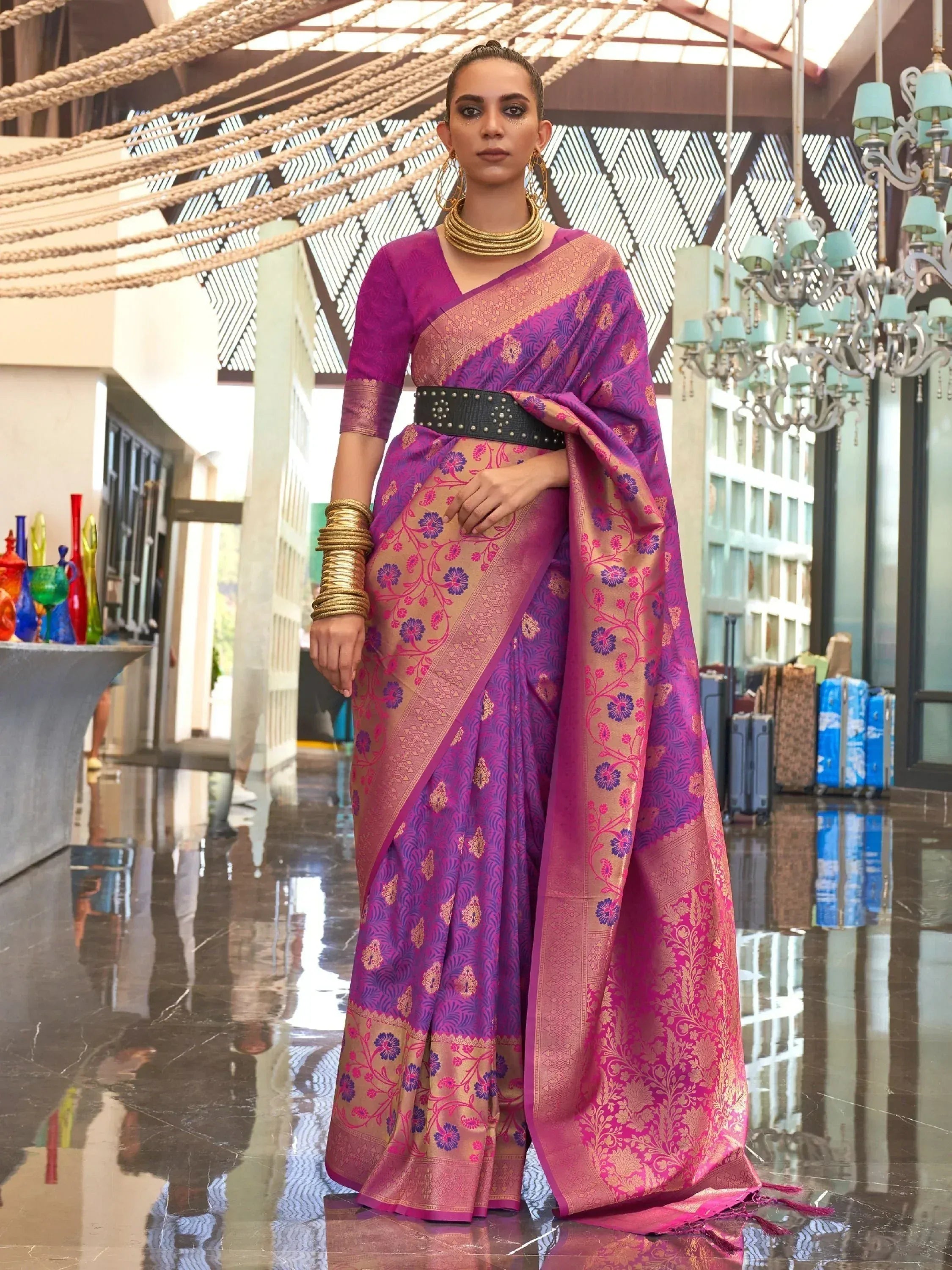 Purple and gold floral designer saree with blouse, styled with gold jewelry and black belt for ethnic wear