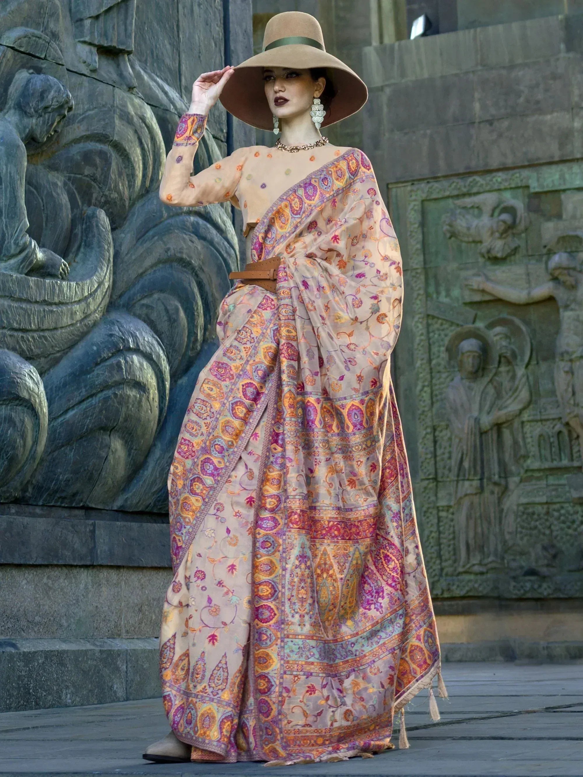 Woman in floral printed saree with wide-brim hat, ethnic wear for festive occasions