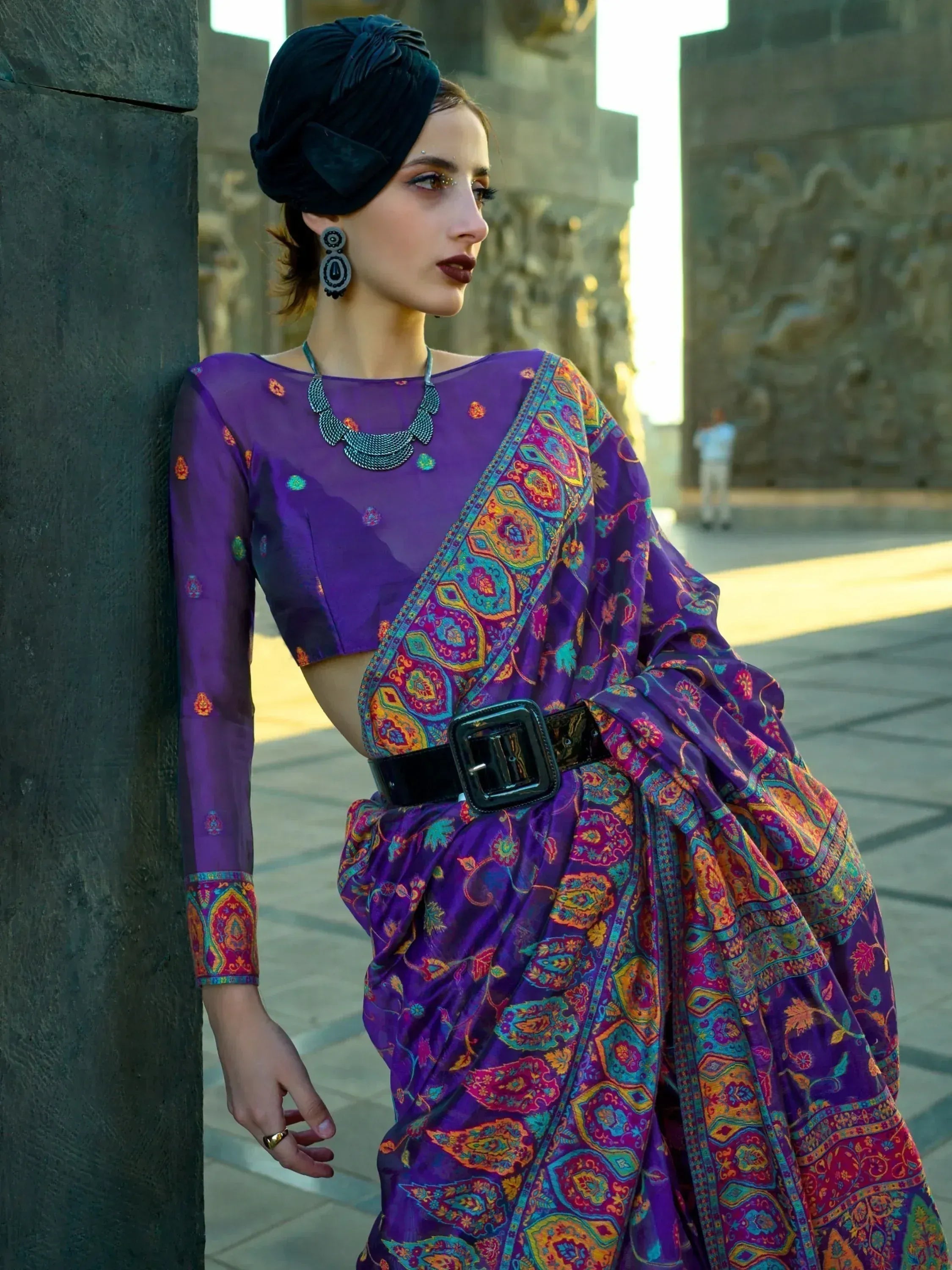 Purple printed ethnic gown with belt, turban, and statement jewelry for Indian fashion