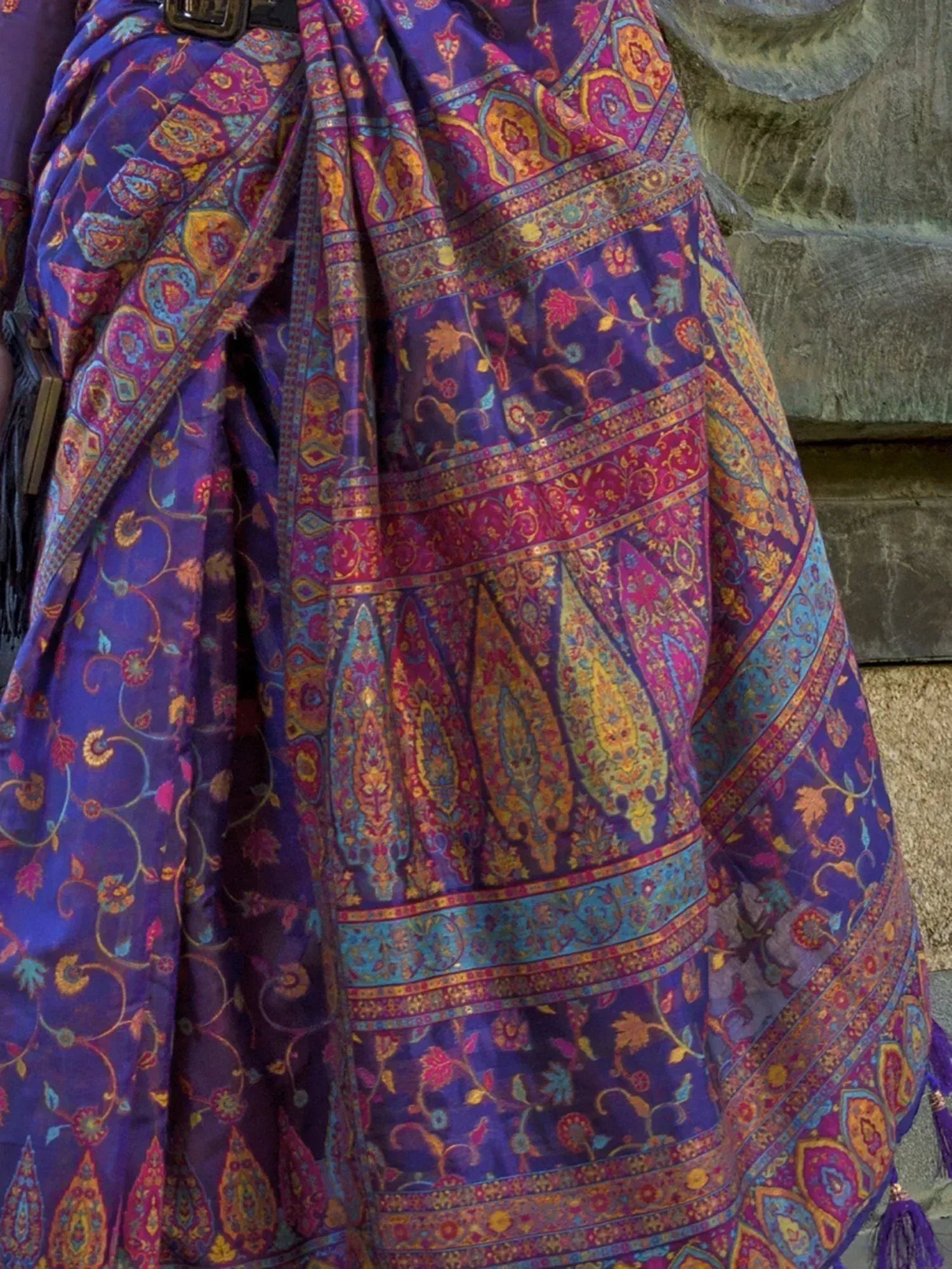 Purple paisley print ethnic saree with vibrant floral motifs and border detailing