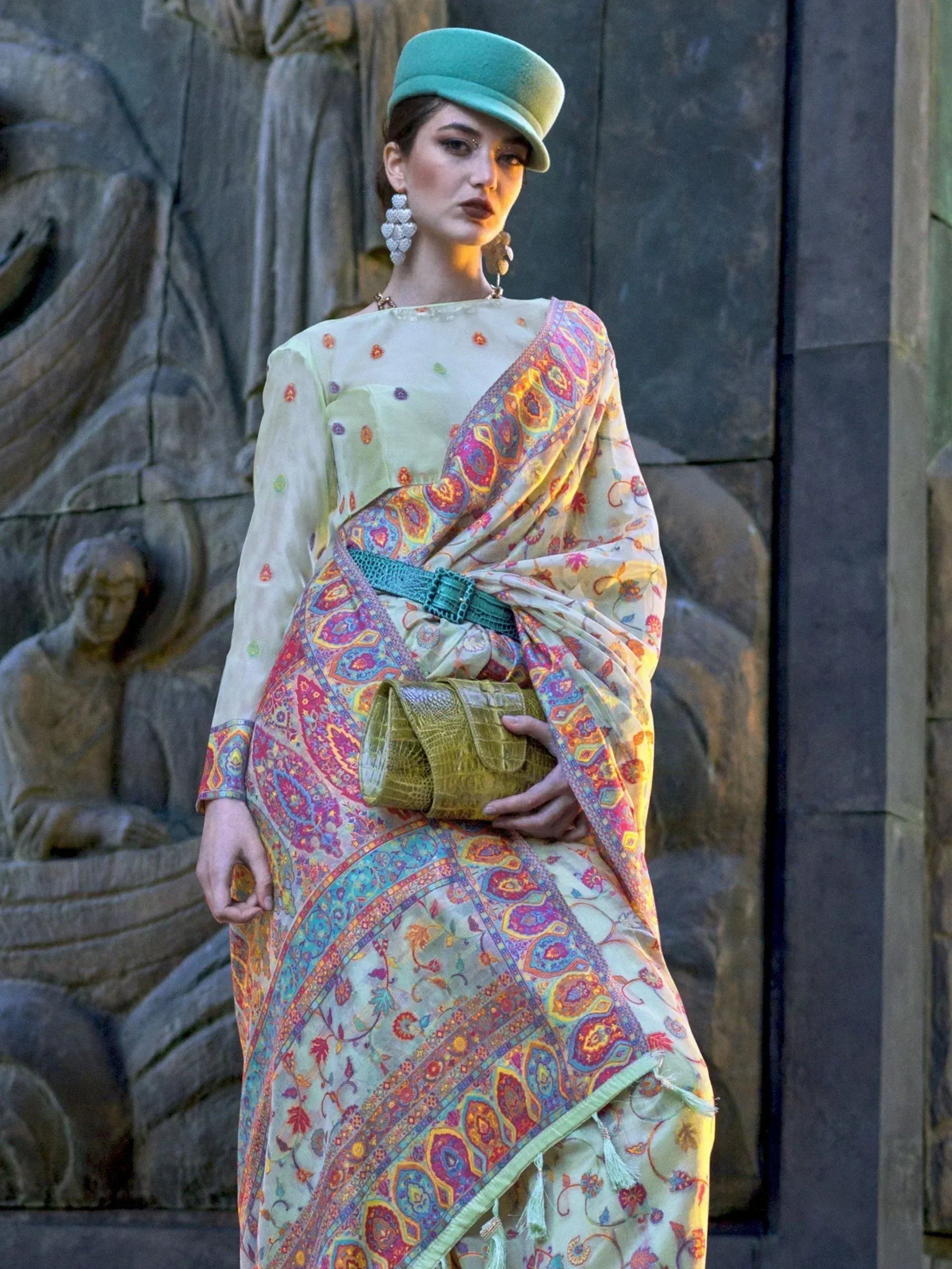 Woman in colorful printed saree with green hat and belt, ethnic wear fashion