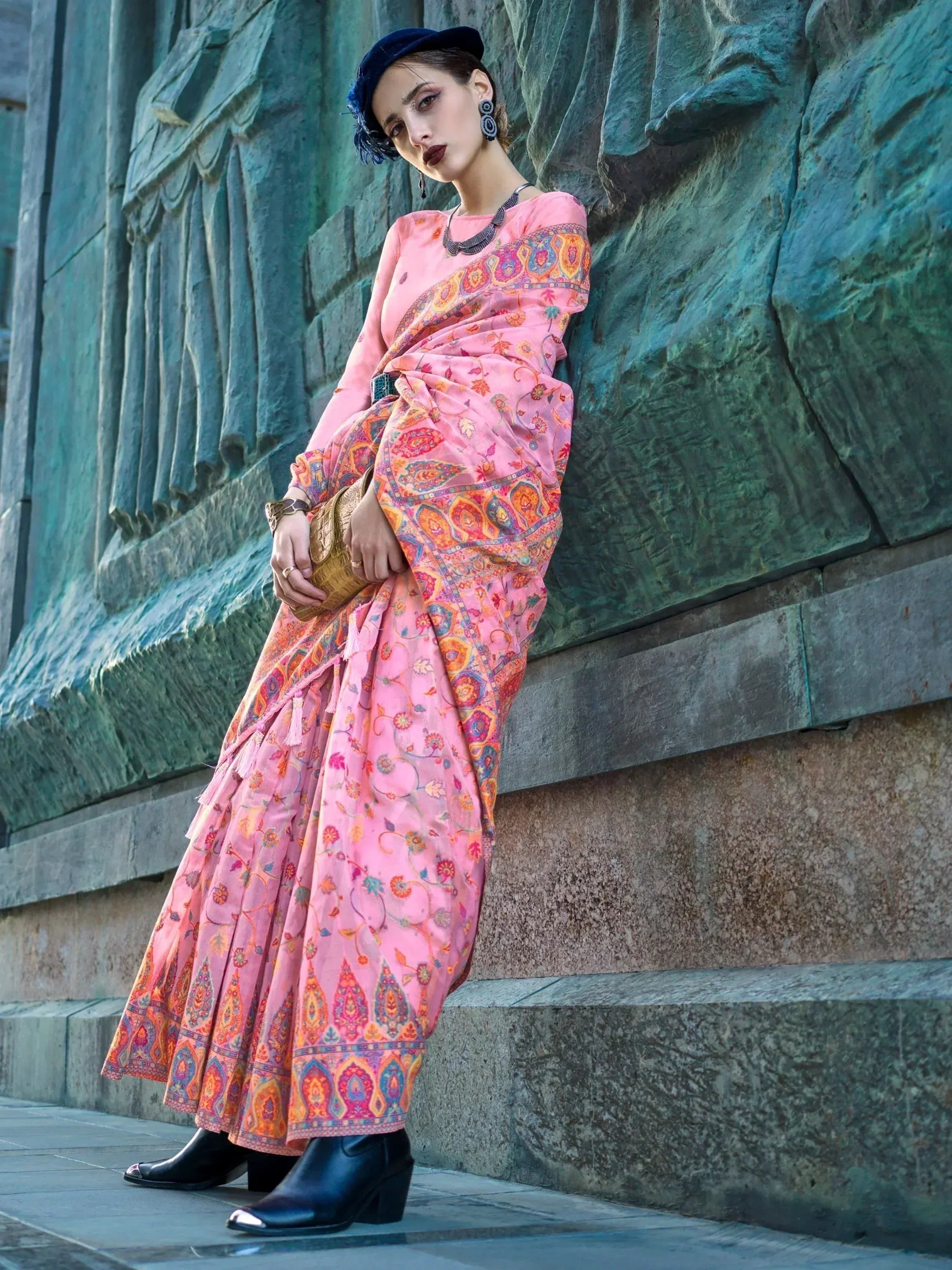 Pink printed ethnic gown with floral paisley design, styled with black boots and beret for modern Indian wear