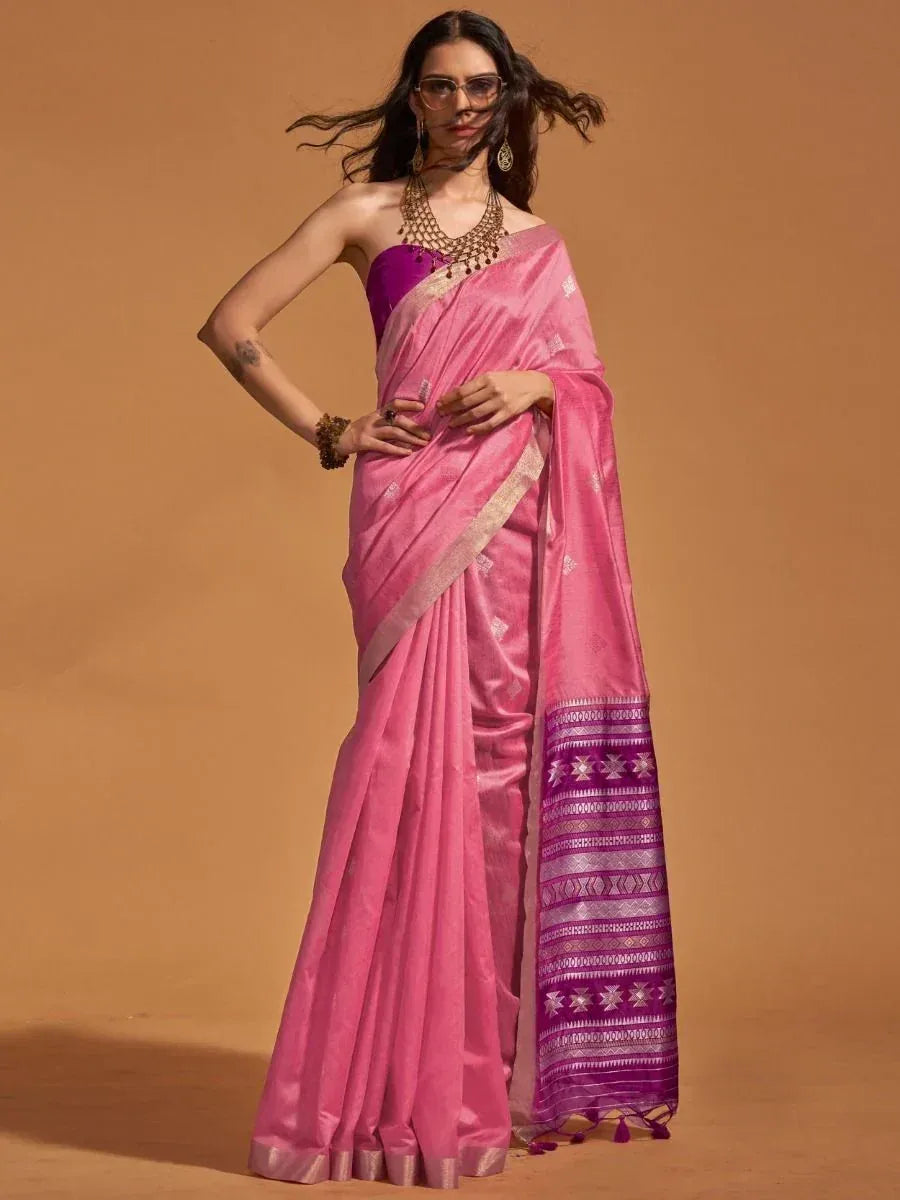 Pink designer saree with purple border and gold embroidery, paired with matching blouse for ethnic wear