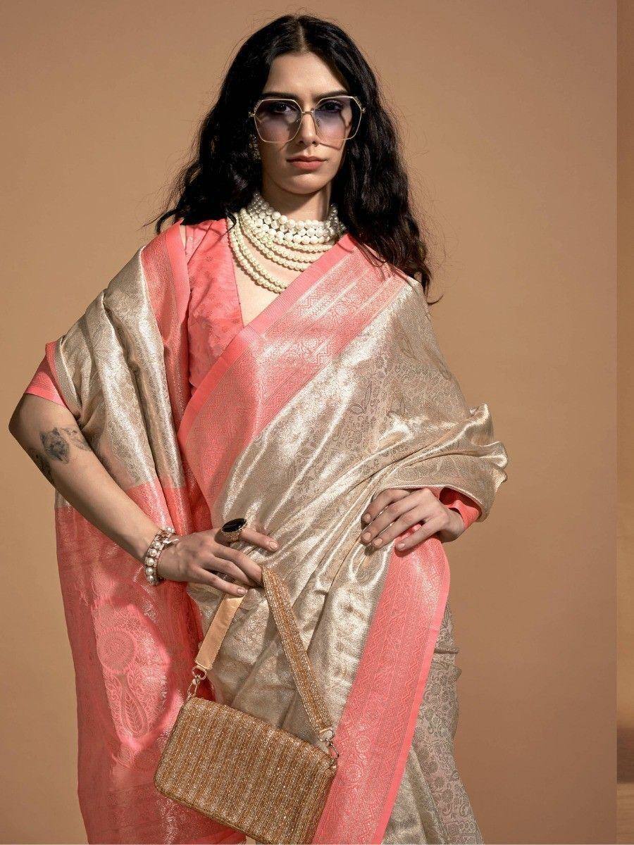 Elegant pink and gold designer saree with pearl necklace and stylish handbag for ethnic wear