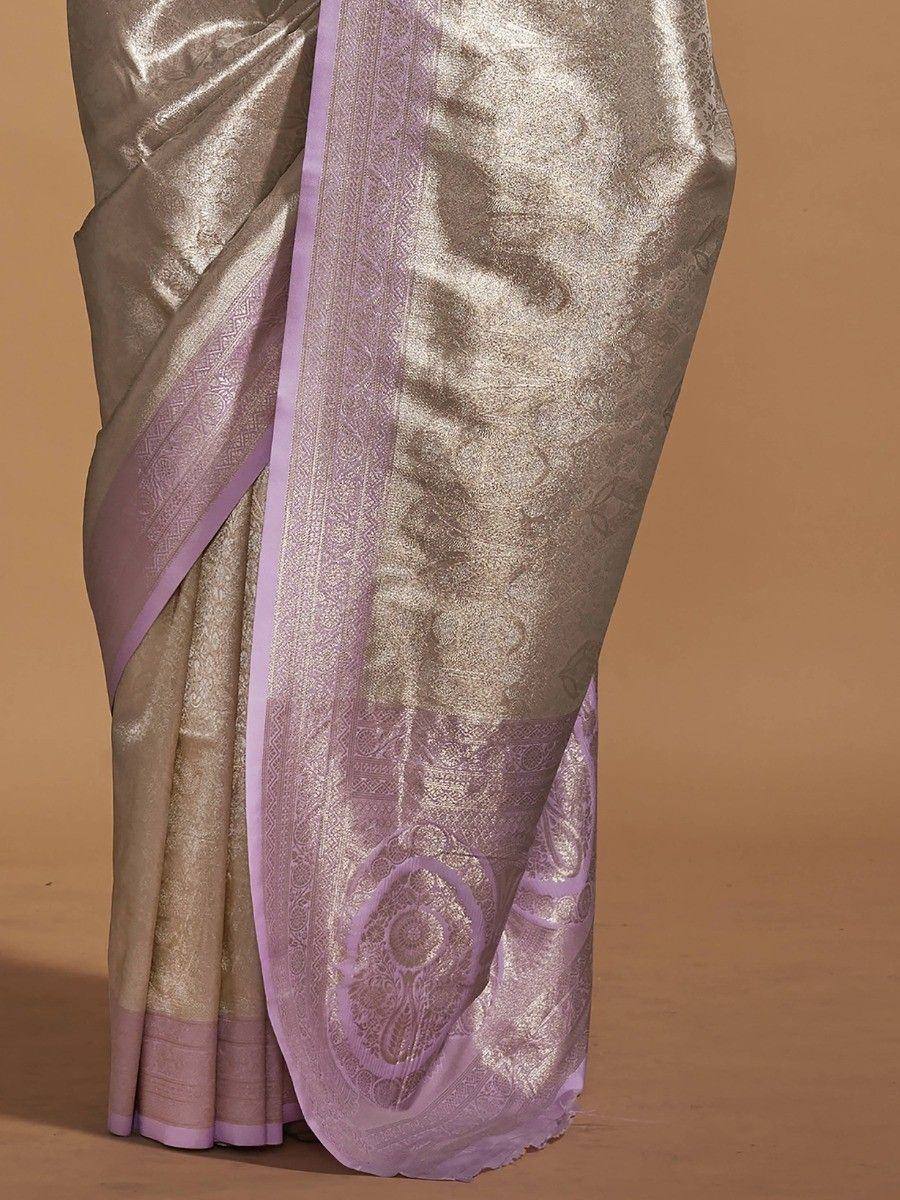 Elegant gold and lavender silk saree with intricate woven border and pallu design, perfect for ethnic occasions.