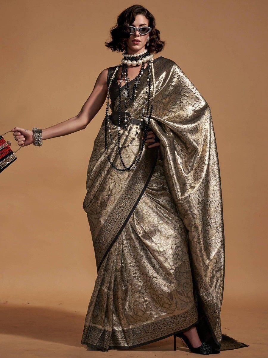 Stylish gold designer saree with black border, paired with pearl necklace and sunglasses for ethnic fashion