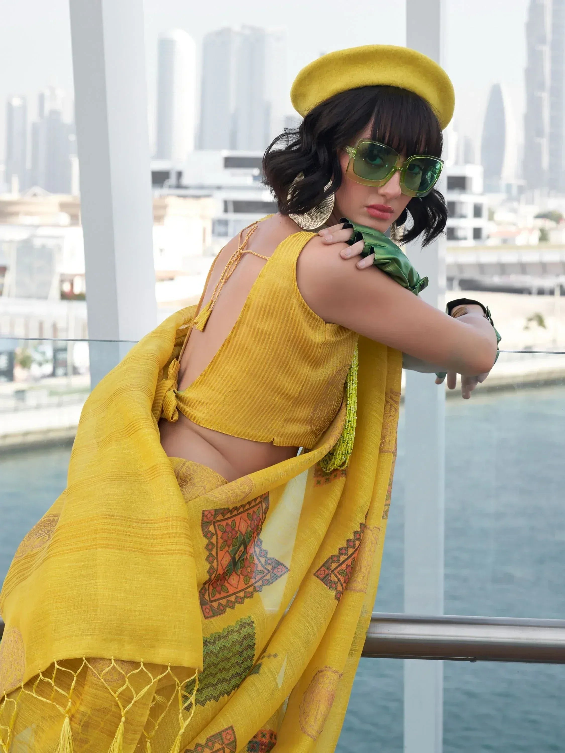 Yellow ethnic saree with printed dupatta, matching crop top, and beret for modern Indian fashion