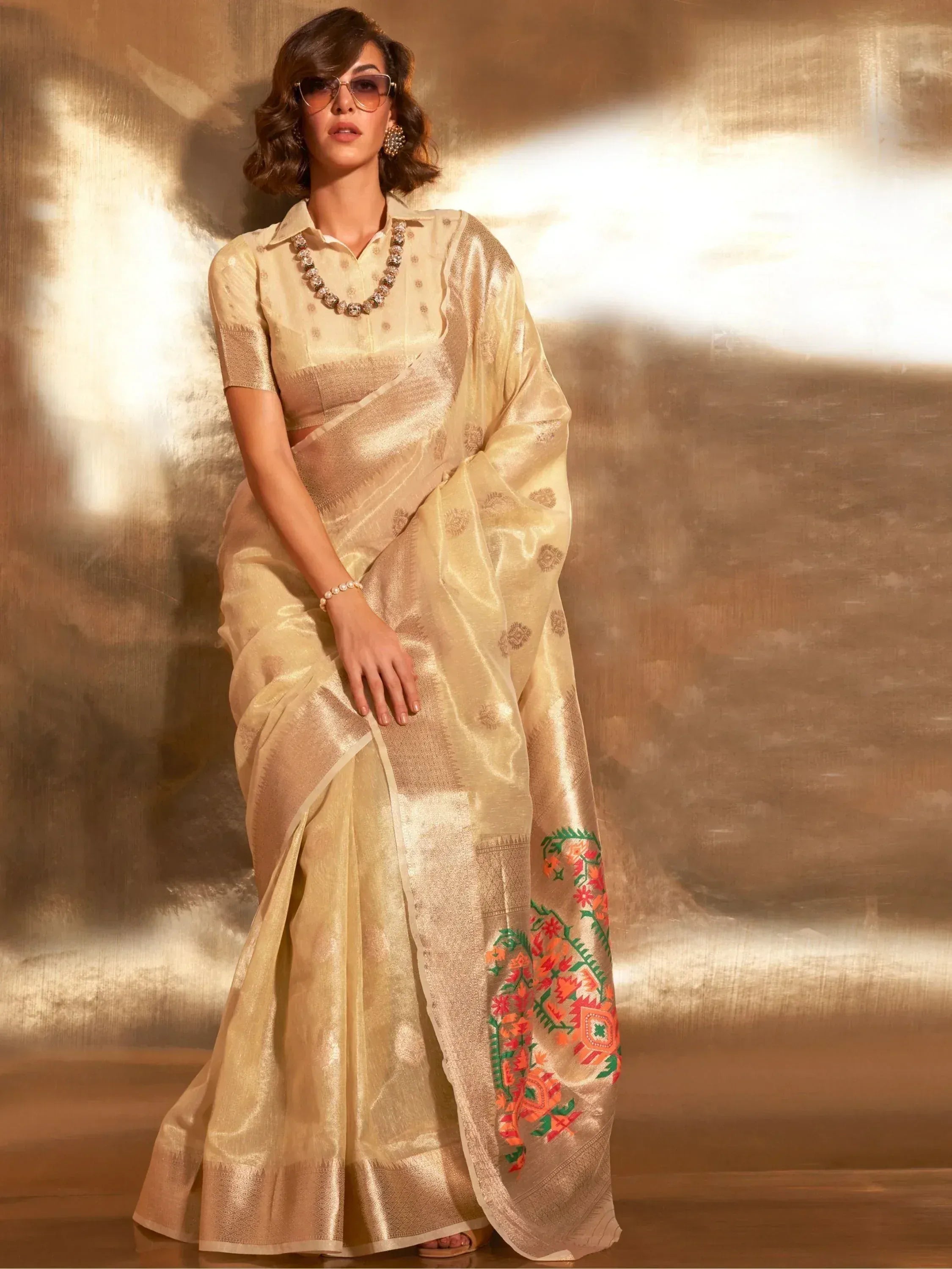 Elegant gold saree with floral embroidery, paired with a matching blouse, perfect for Indian ethnic occasions.